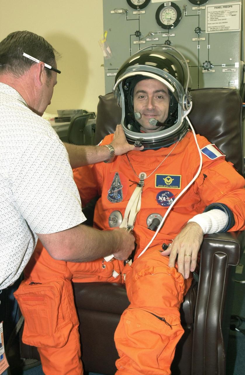 KENNEDY SPACE CENTER, FLA. - STS-111 Mission Specialist Philippe Perrin, with the French Space Agency, undergoes suit check as part of pre-launch activities. The mission, known as Utilization Flight 2, is carrying supplies and equipment to the Station. The payload includes the Multi-Purpose Logistics Module Leonardo, the Mobile Base System, which will be installed on the Mobile Transporter to complete the Canadian Mobile Servicing System, or MSS, and a replacement wrist/roll joint for Canadarm 2. The mechanical arm will then have the capability to "inchworm" from the U.S. Lab Destiny to the MSS and travel along the truss to work sites. Also part of the mission, Expedition 5 will travel to the International Space Station as the replacement crew for Expedition 4, who will return to Earth aboard the orbiter.  Launch is scheduled for May 30, 2002