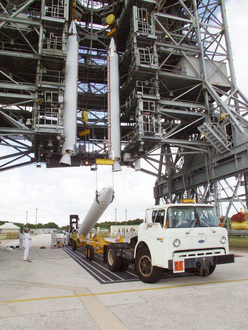 KENNEDY SPACE CENTER, FLA. -- On Launch Pad 17-A, Cape Canaveral Air Force Station, two solid rocket boosters are lifted for mating to a Boeing Delta II rocket, as another waits its turn on the transporter below. The rocket will be the launch vehicle for the CONTOUR spacecraft, scheduled to launch July 1. CONTOUR will provide the first detailed look into the heart of a comet -- the nucleus. The spacecraft will fly close to at least two comets, Encke and Schwassmann-Wachmann 3, taking pictures of the nucleus while analyzing the gas and dust that surround these rocky, icy building blocks of the solar system.