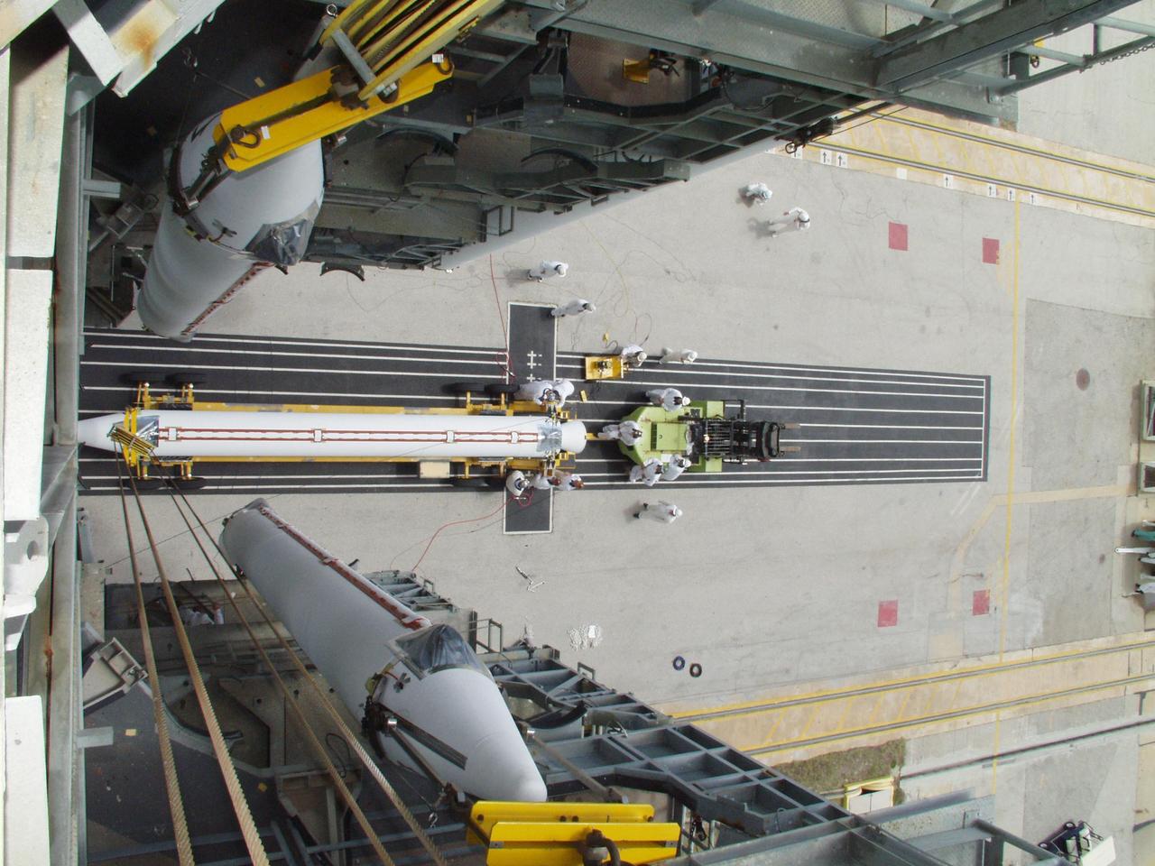 KENNEDY SPACE CENTER, FLA. -- Viewed from the top of Launch Pad 17-A, Cape Canaveral Air Force Station, two solid rocket boosters are lifted for mating to a Boeing Delta II rocket, as another waits its turn on the transporter below. The rocket will be the launch vehicle for the CONTOUR spacecraft, scheduled to launch July 1. CONTOUR will provide the first detailed look into the heart of a comet -- the nucleus. The spacecraft will fly close to at least two comets, Encke and Schwassmann-Wachmann 3, taking pictures of the nucleus while analyzing the gas and dust that surround these rocky, icy building blocks of the solar system.