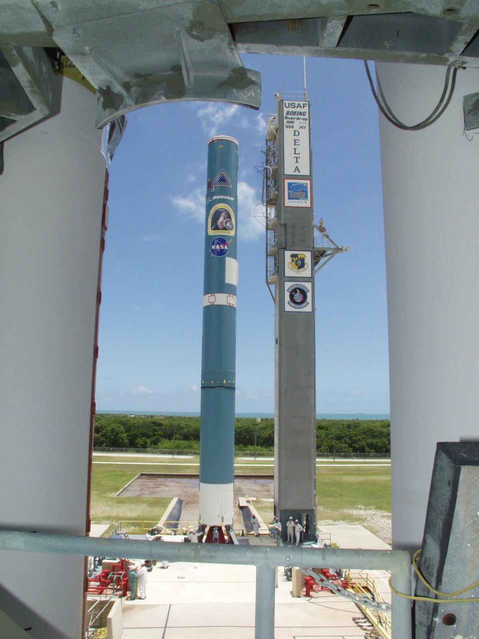 KENNEDY SPACE CENTER, FLA. -- On Launch Pad 17-A, Cape Canaveral Air Force Station, a view of the first stage of a Boeing Delta II rocket is captured between two of the solid rocket boosters that will be mated to it. The rocket will be the launch vehicle for the CONTOUR spacecraft, scheduled to launch July 1. CONTOUR will provide the first detailed look into the heart of a comet -- the nucleus. The spacecraft will fly close to at least two comets, Encke and Schwassmann-Wachmann 3, taking pictures of the nucleus while analyzing the gas and dust that surround these rocky, icy building blocks of the solar system.