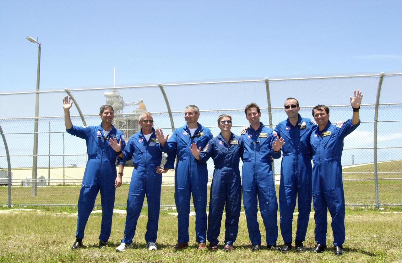 KENNEDY SPACE CENTER, FLA. -- At Launch Pad 39-A, the STS-111 and Expedition Five crews take time out from a tour of the pad with their friends and family to pose for a group portrait. From left, they are STS-111 Pilot Paul Lockhart, STS-111 Commander Kenneth Cockrell, Expedition Five Commander Valeri Korzun (RSA), Expedition Five astronaut Peggy Whitson, Expedition Five cosmonaut Sergei Treschev (RSA), and STS-111 Mission Specialists Philippe Perrin (CNES) and Franklin Chang-Diaz. Expedition Five is traveling to the International Space Station on Space Shuttle Endeavour as the replacement crew for Expedition Four, who will return to Earth aboard the orbiter. Known as Utilization Flight 2, STS-111 is carrying supplies and equipment to the Station. The payload includes the Multi-Purpose Logistics Module Leonardo, the Mobile Base System, which will be installed on the Mobile Transporter to complete the Canadian Mobile Servicing System, or MSS, and a replacement wrist/roll joint for Canadarm 2. The mechanical arm will then have the capability to "inchworm" from the U.S. Lab Destiny to the MSS and travel along the truss to work sites. Launch is scheduled for May 30, 2002