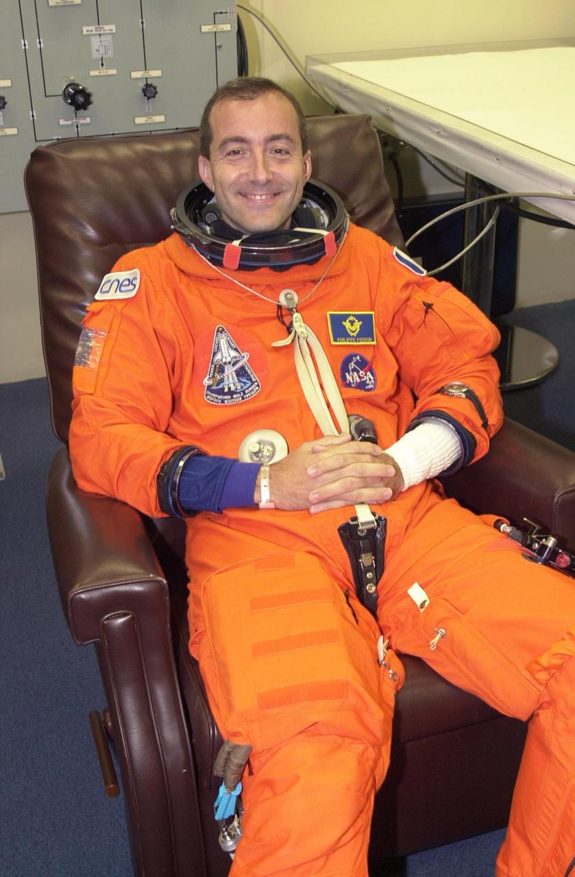 KENNEDY SPACE CENTER, FLA. - STS-111 Mission Specialist Philippe Perrin (CNES) smiles during suitup for the scheduled liftoff of Space Shuttle Endeavour at 7:44 p.m. EDT.  This is Perrin's first Shuttle flight. STS-111 is the second Utilization Flight to the International Space Station, carrying the Multi-Purpose Logistics Module Leonardo, the Mobile Base System (MBS), and a replacement wrist/roll joint for the Canadarm 2. The MBS will be installed on the Mobile Transporter to complete the Canadian Mobile Servicing System, or MSS.  In addition, Expedition 5 is traveling on mission STS-111 to the International Space Station to replace the current resident crew, Expedition 4, who will return to Earth with the STS-111 crew