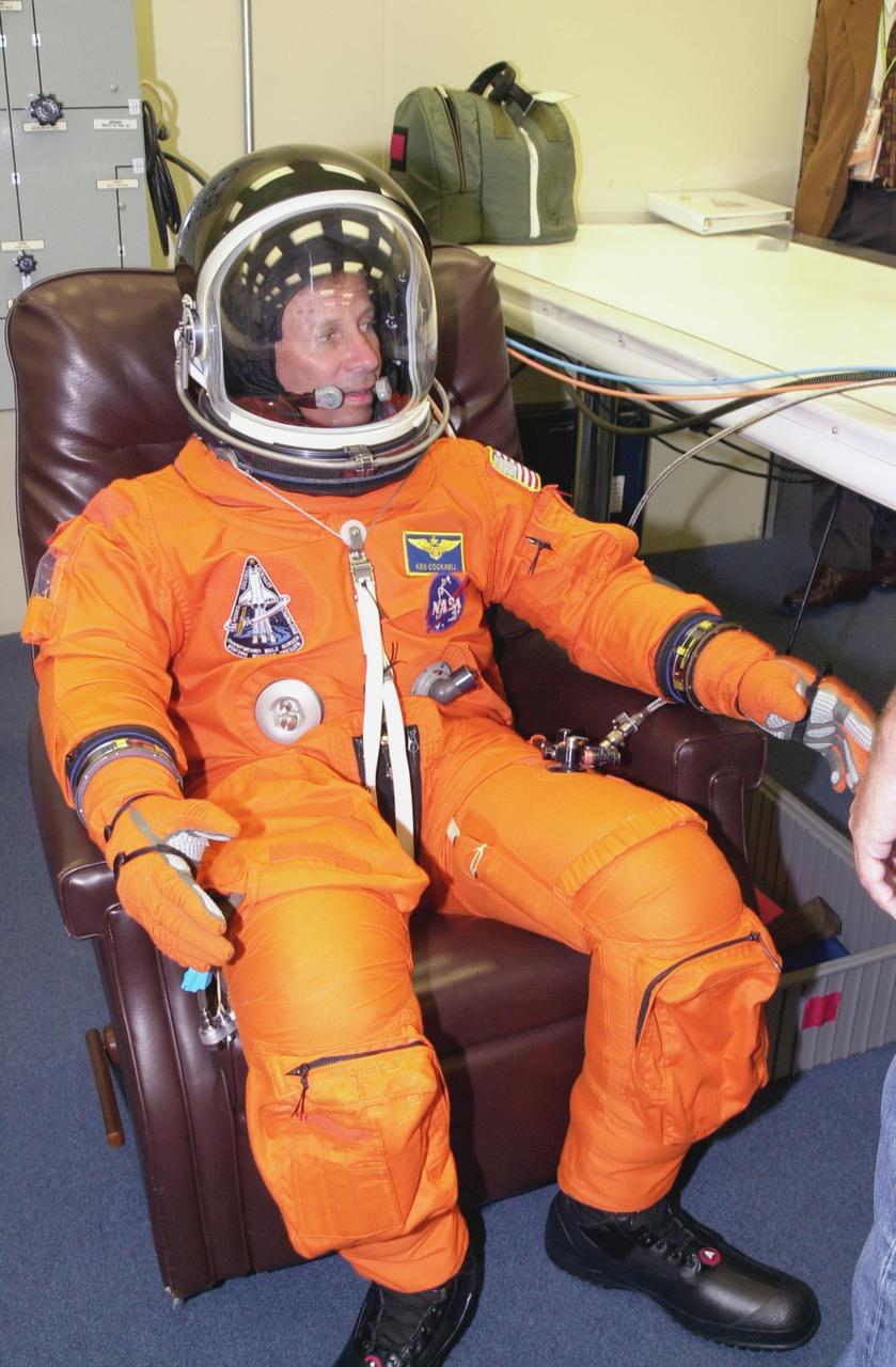 KENNEDY SPACE CENTER, FLA. - STS-111 Commander Kenneth Cockrell suits up for the scheduled liftoff of Space Shuttle Endeavour at 7:44 p.m. EDT.  This is Cockrell's fifth Shuttle flight. STS-111 is the second Utilization Flight to the International Space Station, carrying the Multi-Purpose Logistics Module Leonardo, the Mobile Base System (MBS), and a replacement wrist/roll joint for the Canadarm 2. The MBS will be installed on the Mobile Transporter to complete the Canadian Mobile Servicing System, or MSS.  In addition, Expedition 5 is traveling on mission STS-111 to the International Space Station to replace the current resident crew, Expedition 4, who will return to Earth with the STS-111 crew