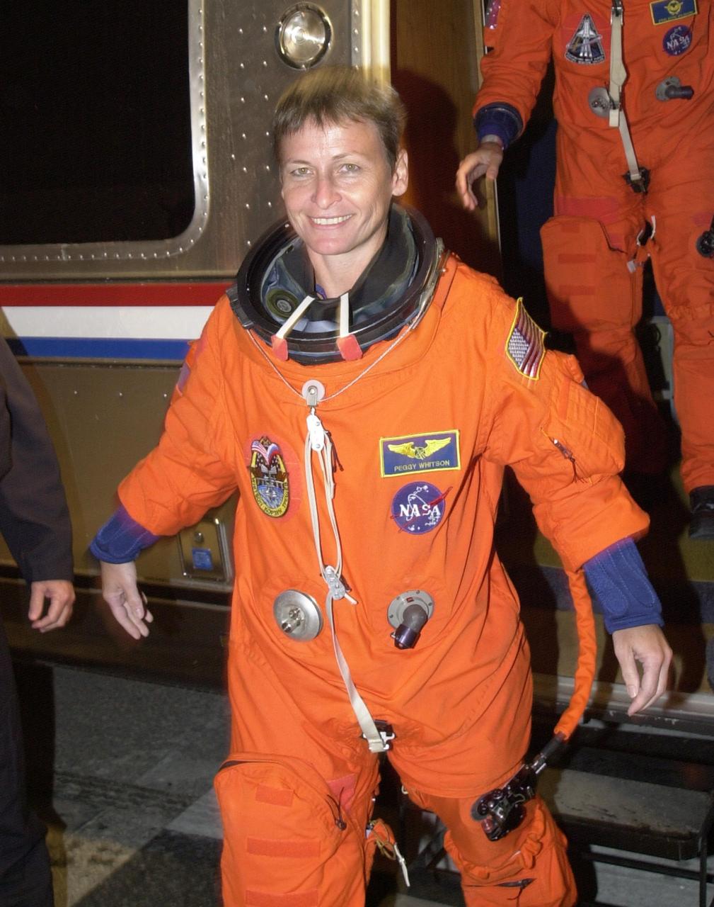 KENNEDY SPACE CENTER, FLA. - Expedition 5 astronaut Peggy Whitson steps down from the Astrovan outside the crew quarters at the Operations and Checkout Building after returning from Space Shuttle Endeavour at Launch Pad 39A. The launch of STS-111 was scrubbed due to poor weather at KSC. STS-111 is the second Utilization Flight to the International Space Station, carrying the Multi-Purpose Logistics Module Leonardo, the Mobile Base System (MBS), and a replacement wrist/roll joint for the Canadarm 2. Also on board will be the Expedition Five crew who will replace Expedition Four on the Station. Launch is rescheduled for May 31 at 7:22 p.m. EDT