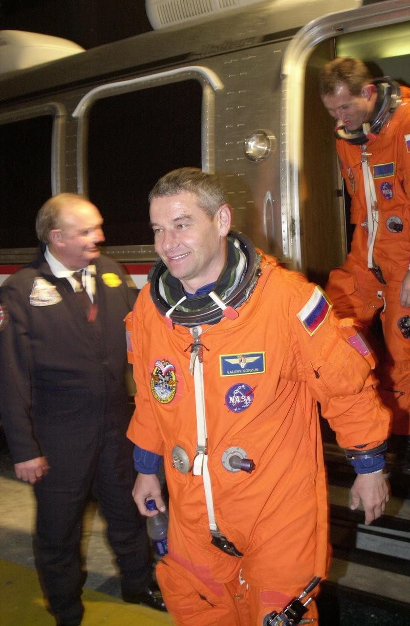 KENNEDY SPACE CENTER, FLA. -- Expedition 5 Commander Valery Korzun (RSA) steps down from the Astrovan outside the crew quarters at the Operations and Checkout Building after returning from Space Shuttle Endeavour at Launch Pad 39A. The launch of STS-111 was scrubbed due to poor weather at KSC. STS-111 is the second Utilization Flight to the International Space Station, carrying the Multi-Purpose Logistics Module Leonardo, the Mobile Base System (MBS), and a replacement wrist/roll joint for the Canadarm 2. Also on board will be the Expedition Five crew who will replace Expedition Four on the Station. Launch is rescheduled for May 31 at 7:22 p.m. EDT