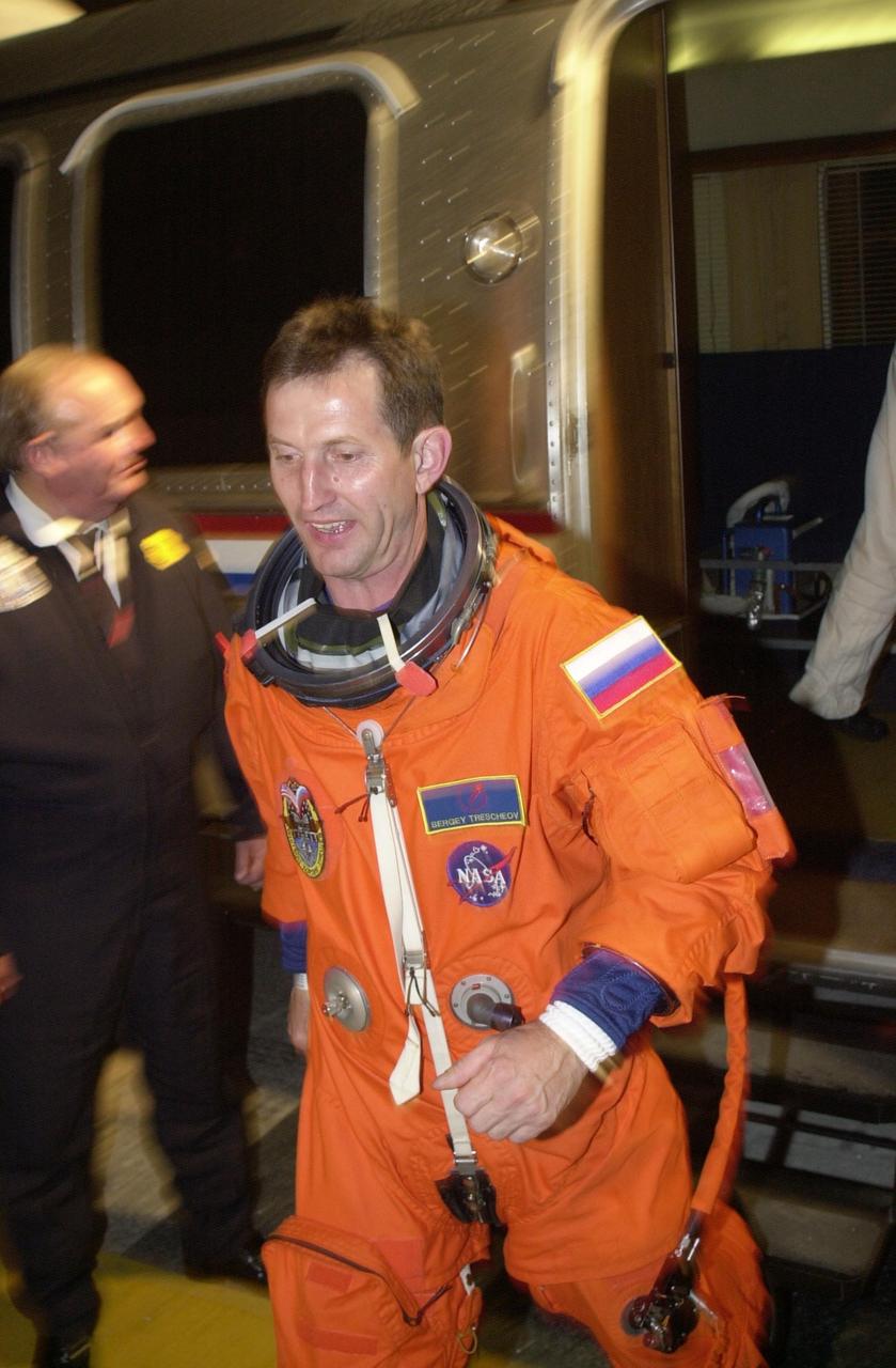 KENNEDY SPACE CENTER, FLA. -- Expedition 5 cosmonaut Sergei Treschev (RSA) steps down from the Astrovan outside the crew quarters at the Operations and Checkout Building after returning from Space Shuttle Endeavour at Launch Pad 39A. The launch of STS-111 was scrubbed due to poor weather at KSC. STS-111 is the second Utilization Flight to the International Space Station, carrying the Multi-Purpose Logistics Module Leonardo, the Mobile Base System (MBS), and a replacement wrist/roll joint for the Canadarm 2. Also on board will be the Expedition Five crew who will replace Expedition Four on the Station. Launch is rescheduled for May 31 at 7:22 p.m. EDT