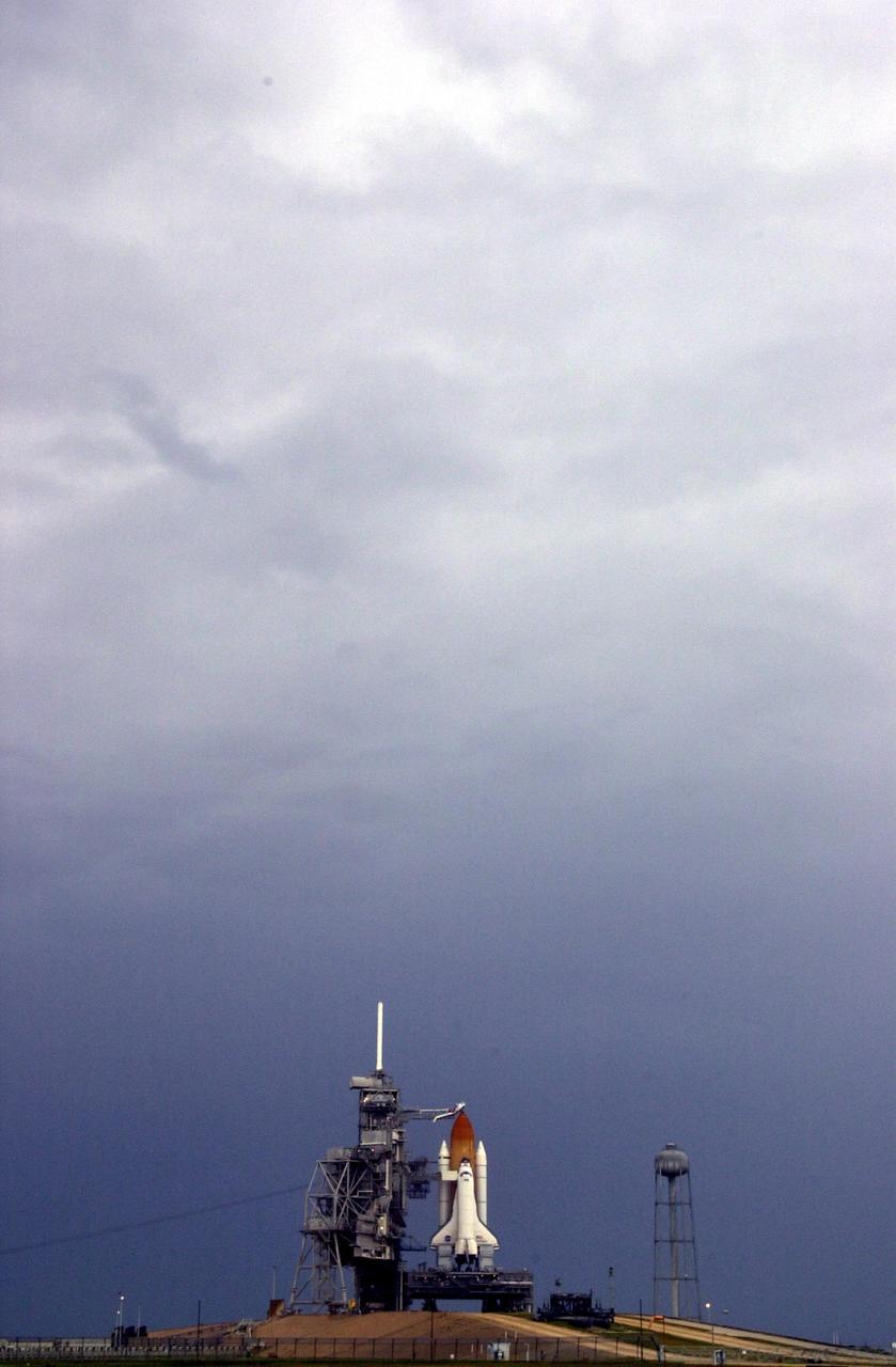 KENNEDY SPACE CENTER, FLA. -- Space Shuttle Endeavour is poised for launch at Pad 39A after mission managers postponed today's launch of mission STS-111.  Forecasters' predictions that weather would prohibit a launch attempt due to severe thunderstorms and rain showers within the vicinity of the launch pad were accurate as depicted by the dark clouds overhead.  STS-111 is the second Utilization Flight to the International Space Station, carrying the Multi-Purpose Logistics Module Leonardo, the Mobile Base System (MBS), and a replacement wrist/roll joint for the Canadarm 2. Also on board will be the Expedition Five crew who will replace Expedition Four on the Station. Launch has been rescheduled for Monday, June 3, between 4 and 8 p.m. EDT