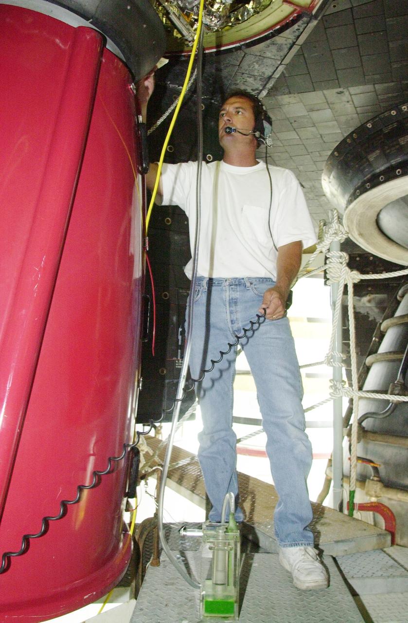 KENNEDY SPACE CENTER, FLA. -- United Space Alliance Aft Technician Bobby Wright checks is the gaseous nitrogen pressure regulator in the left Orbital Maneuvering System pod on Space Shuttle Endeavour. The component showed pressure differentials during the launch count May 30, 2002, and mission managers elected to replace it after the launch was scrubbed due to weather concerns. The launch of Endeavour on Mission STS-111, Utilization Flight 2 to the International Space Station, has been rescheduled for June 5, 2002
