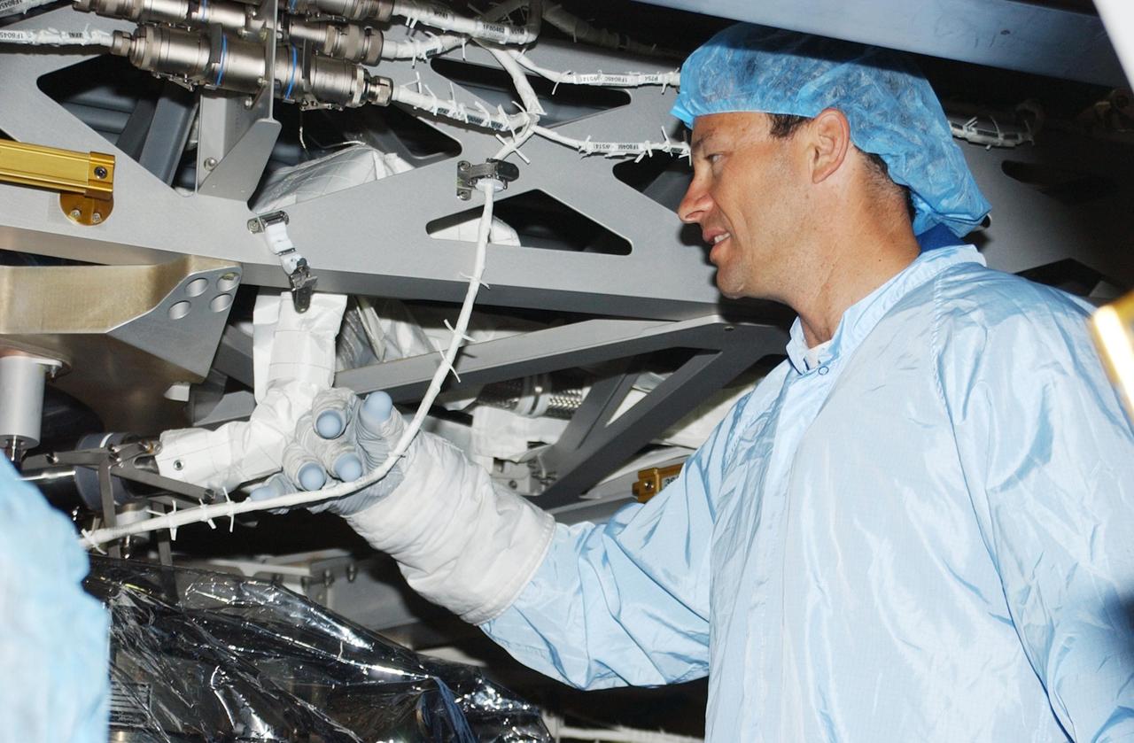 KENNEDY SPACE CENTER, FLA. -- STS-113 Mission Specialist Michael Lopez-Alegria looks over the P1 Integrated Truss Structure, the primary payload for the mission. The P1 truss will be attached to the central truss segment, S0 Truss, during spacewalks. The payload also includes the Crew and Equipment Translation Aid (CETA) Cart B that can be used by spacewalkers to move along the truss with equipment. STS-113 is scheduled to launch Oct. 6, 2002.
