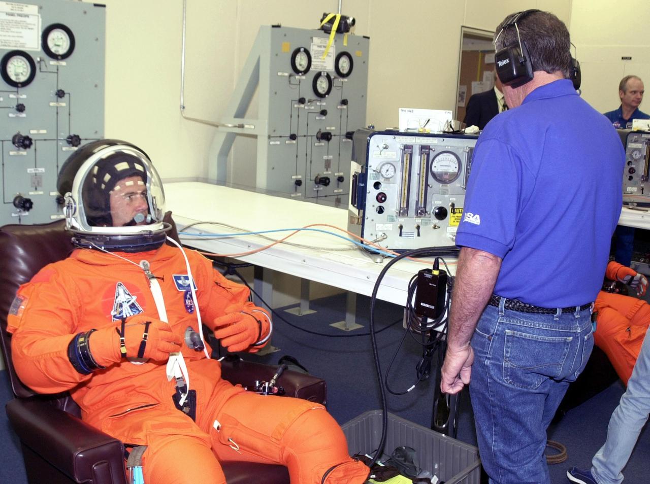 KENNEDY SPACE CENTER, FLA. -- STS-111 Pilot Paul Lockhart gets his helmet checked during suitup for the second launch attempt aboard Space Shuttle Endeavour on mission STS-111 to the International Space Station.  This is Lockhart's first Shuttle flight.  This mission marks the 14th Shuttle flight to the Space Station and the third Shuttle mission this year. Mission STS-111 is the 18th flight of Endeavour and the 110th flight overall in NASA's Space Shuttle program.  On mission STS-111, astronauts will deliver the Leonardo Multi-Purpose Logistics Module, the Mobile Base System (MBS), and the Expedition Five crew to the Space Station. During the seven days Endeavour will be docked to the Station, three spacewalks will be performed dedicated to installing MBS and the replacement wrist-roll joint on the Station's Canadarm2 robotic arm. Endeavour will also carry the Expedition 5 crew, who will replace Expedition 4 on board the Station. Expedition 4 crew members will return to Earth with the STS-111 crew. Liftoff is scheduled for 5:22 p.m. EDT from Launch Pad 39A