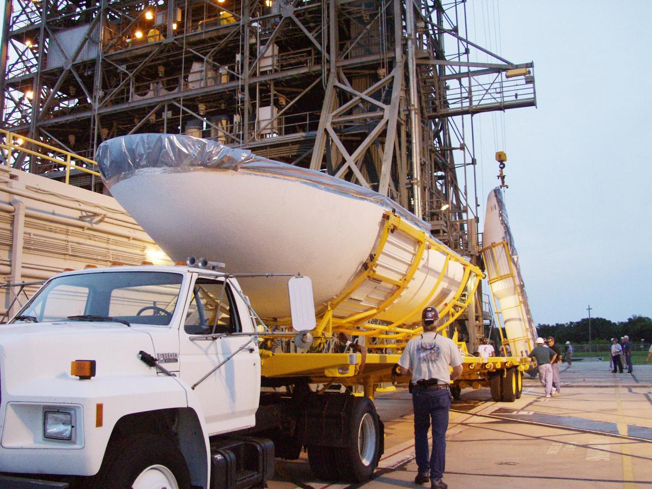 KENNEDY SPACE CENTER, FLA. -- At Launch Complex 17-A, Cape Canaveral Air Force Station, the fairing of the Delta II rocket arrives for encapsulation of the Comet Nucleus Tour (CONTOUR) spacecraft. CONTOUR will provide the first detailed look into the heart of a comet -- the nucleus. Flying as close as 60 miles (100 kilometers) to at least two comets, the spacecraft will take the sharpest pictures yet of a nucleus while analyzing the gas and dust that surround them. Launch of CONTOUR is scheduled for July 1, 2002