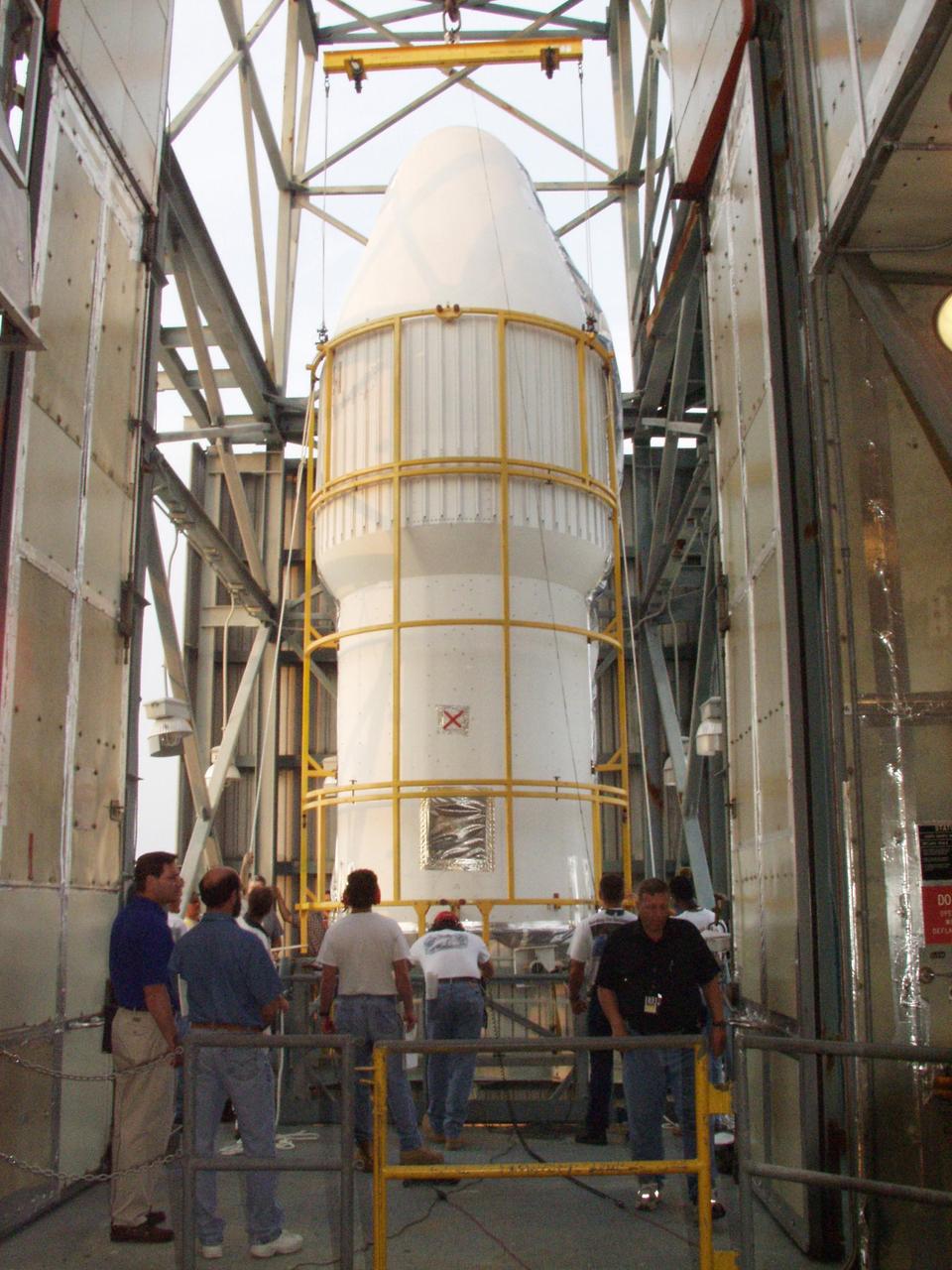 KENNEDY SPACE CENTER, FLA. - At Launch Complex 17-A, Cape Canaveral Air Force Station, one part of the fairing that will encapsulate the Comet Nucleus Tour (CONTOUR) spacecraft on a Delta II rocket arrives at the top of the launch tower. CONTOUR will provide the first detailed look into the heart of a comet -- the nucleus. Flying as close as 60 miles (100 kilometers) to at least two comets, the spacecraft will take the sharpest pictures yet of a nucleus while analyzing the gas and dust that surround them. Launch of CONTOUR is scheduled for July 1, 2002