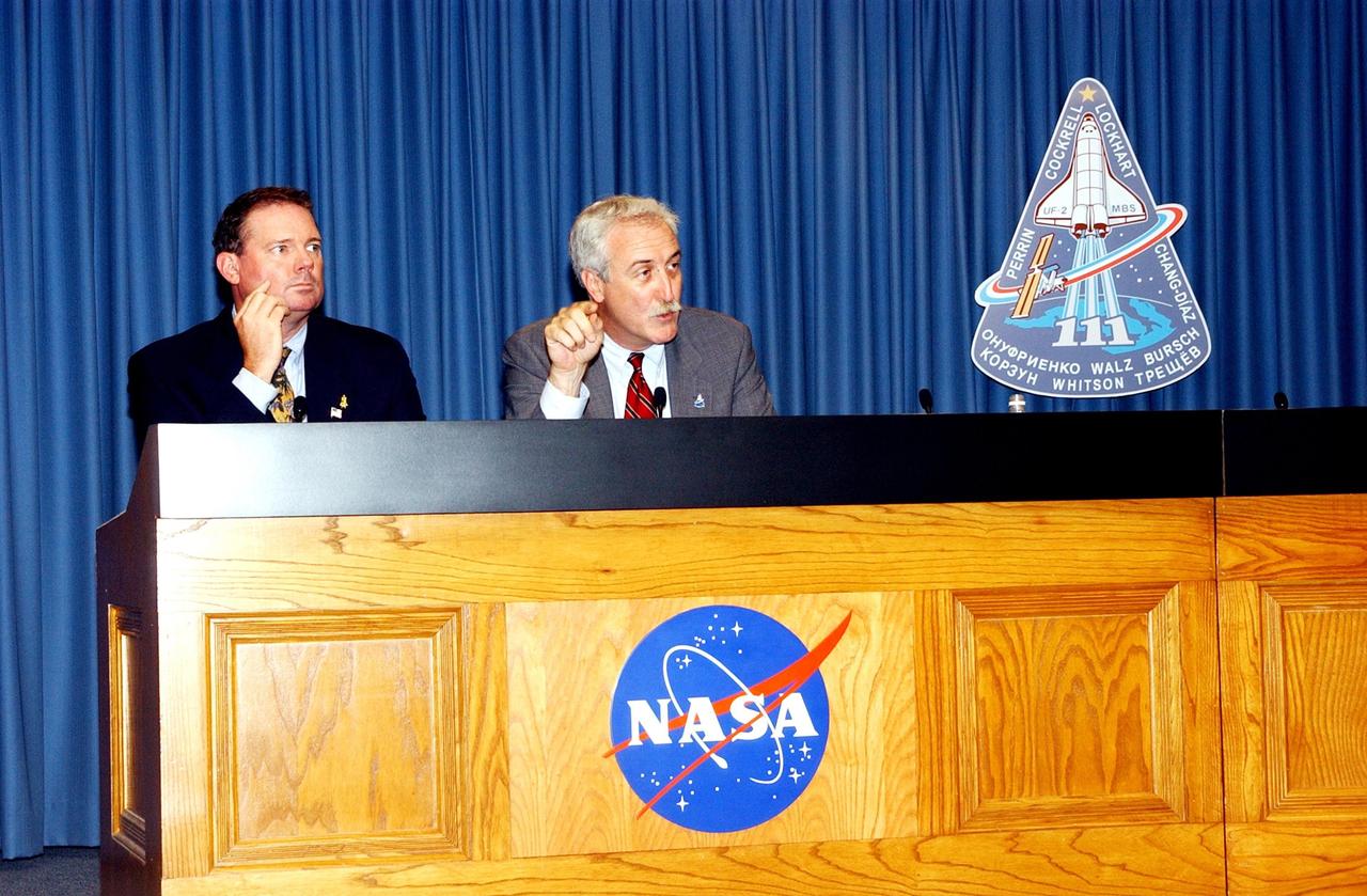 KENNEDY SPACE CENTER, FLA. -- Following the successful launch of Space Shuttle Endeavour on mission STS-111 today, NASA Administrator Sean O'Keefe (right) talks to the media in a briefing in the NASA/KSC television studio.  At left is Kyle Herring, public affairs office, Johnson Space Center, who moderated. 