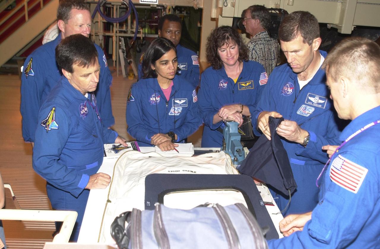 KENNEDY SPACE CENTER, FLA. --   During Crew Equipment Interface Test activities, the STS-107 crew looks at flight equipment in the Orbiter Processing Facility.  Seen left to right are Payload Specialist Ilan Ramon, who is with the Israeli Space Agency, Mission Specialists David Brown and Kalpana Chawla, Commander Rick Husband and Pilot William "Willie" McCool.  Behind Chawla is Payload Commander Michael Anderson. STS-107 is a research mission, with the SHI Research Double Module (SHI/RDM), also known as SPACEHAB, as the primary payload, plus the Fast Reaction Experiments Enabling Science, Technology, Applications and Research (FREESTAR) that incorporates eight high priority secondary attached shuttle experiments.  STS-107 is scheduled to launch July 19, 2002