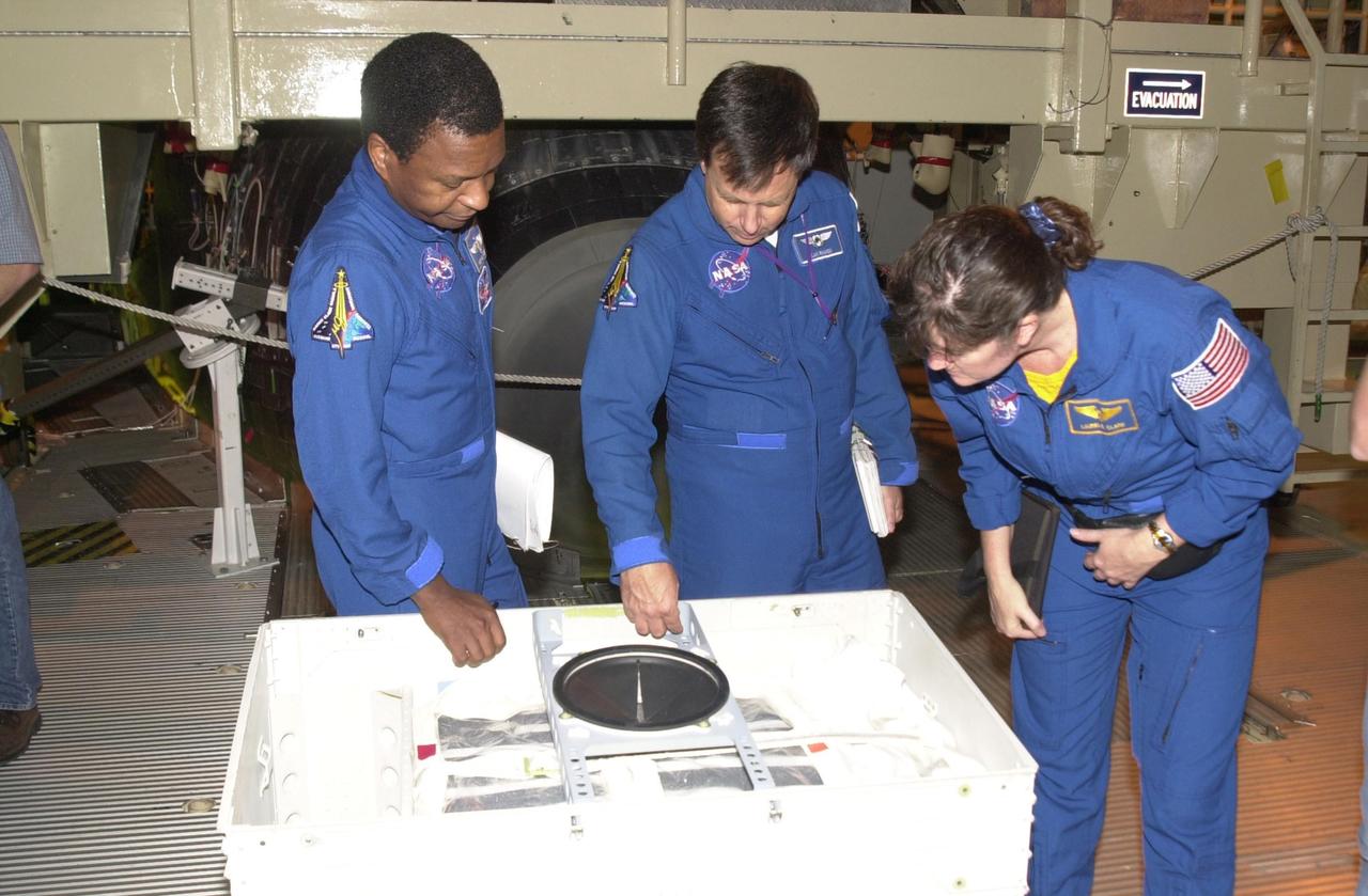 KENNEDY SPACE CENTER, FLA. -- During Crew Equipment Interface Test activities, the STS-107 crew looks at flight equipment in the Orbiter Processing Facility. From left are Payload Commander Michael Anderson, Payload Specialist Ilan Ramon (with the Israeli Space Agency), and Mission Specialist Laurel Clark. STS-107 is a research mission, with the SHI Research Double Module (SHI/RDM), also known as SPACEHAB, as the primary payload, plus the Fast Reaction Experiments Enabling Science, Technology, Applications and Research (FREESTAR) that incorporates eight high priority secondary attached shuttle experiments. STS-107 is scheduled to launch July 19, 2002