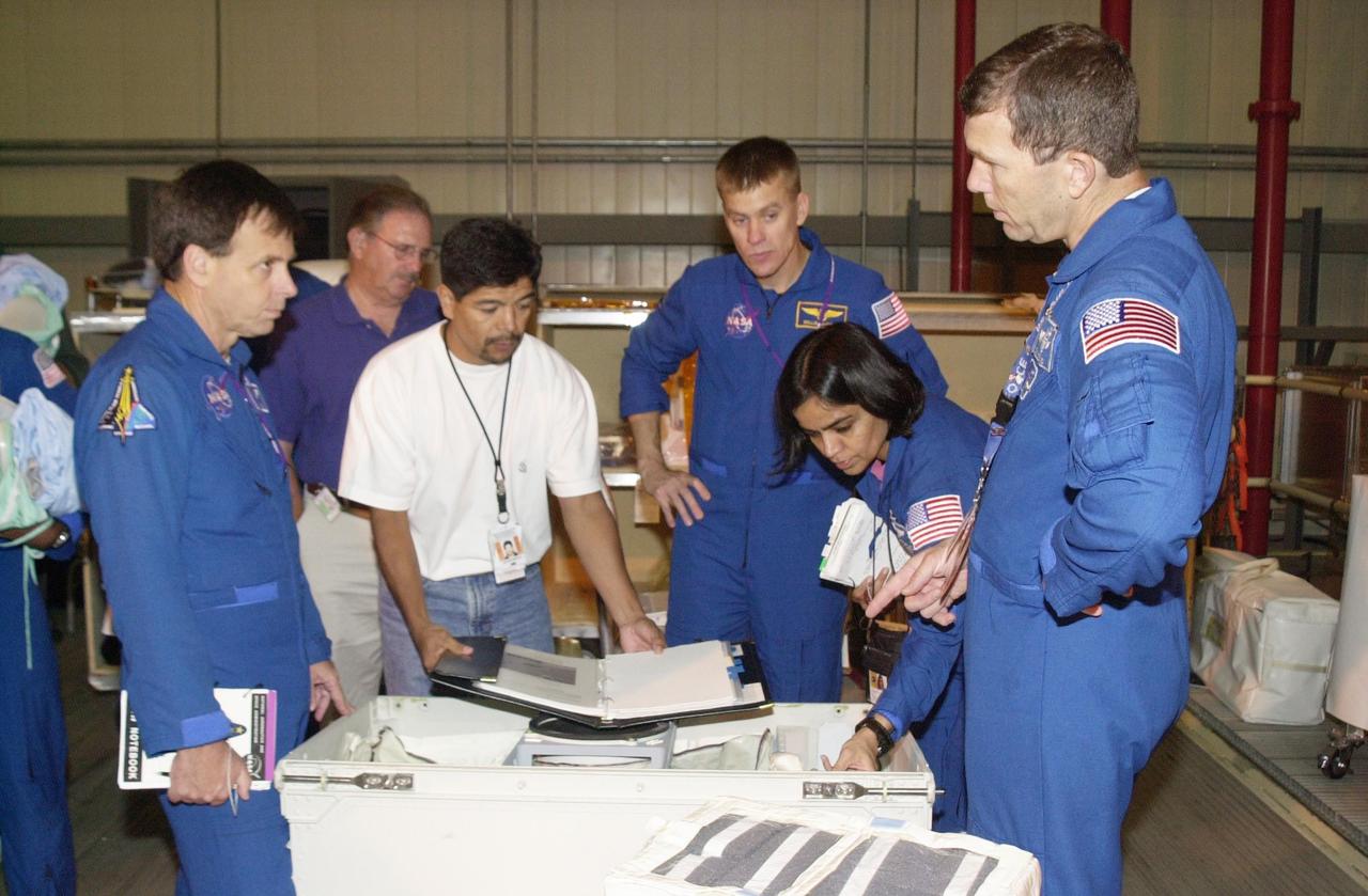 KENNEDY SPACE CENTER, FLA. -- During Crew Equipment Interface Test activities, the STS-107 crew looks at flight equipment in the Orbiter Processing Facility. From left are Payload Specialist Ilan Ramon (with the Israeli Space Agency), Pilot William "Willie" McCool (center), Mission Specialist Kalpana Chawla and Commander Rick Husband. STS-107 is a research mission, with the SHI Research Double Module (SHI/RDM), also known as SPACEHAB, as the primary payload, plus the Fast Reaction Experiments Enabling Science, Technology, Applications and Research (FREESTAR) that incorporates eight high priority secondary attached shuttle experiments. STS-107 is scheduled to launch July 19, 2002