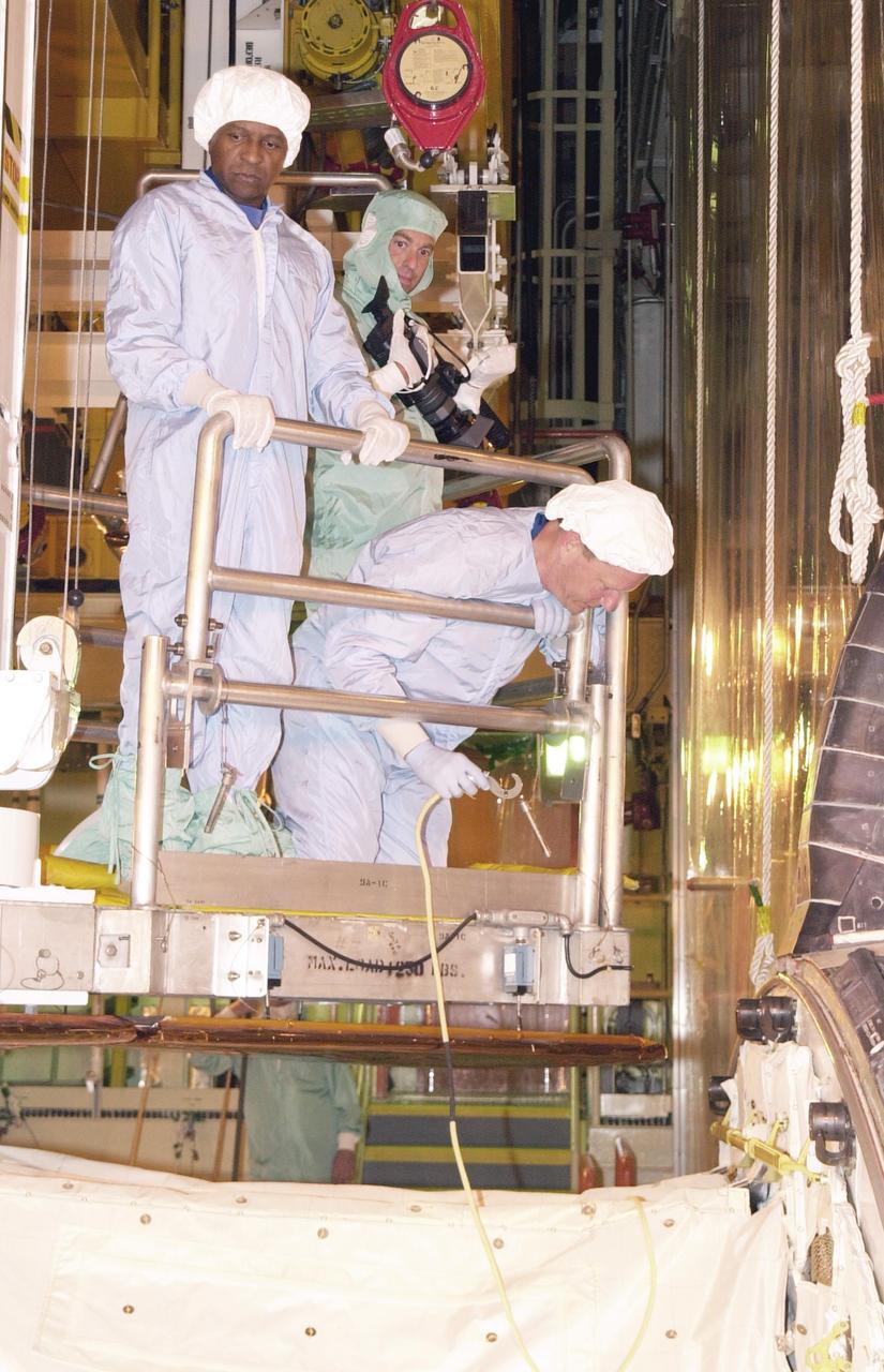 KENNEDY SPACE CENTER, FLA. -- - During Crew Equipment Interface Test activities,  STS-107 Mission Specialist David Brown checks equipment in the payload bay of  Columbia.  At left is Payload Commander Michael Anderson.  A technician holds a camera.   STS-107 is a research mission, with the SHI Research Double Module (SHI/RDM), also known as SPACEHAB, as the primary payload, plus the Fast Reaction Experiments Enabling Science, Technology, Applications and Research (FREESTAR) that incorporates eight high priority secondary attached shuttle experiments.  STS-107 is scheduled to launch July 19, 2002