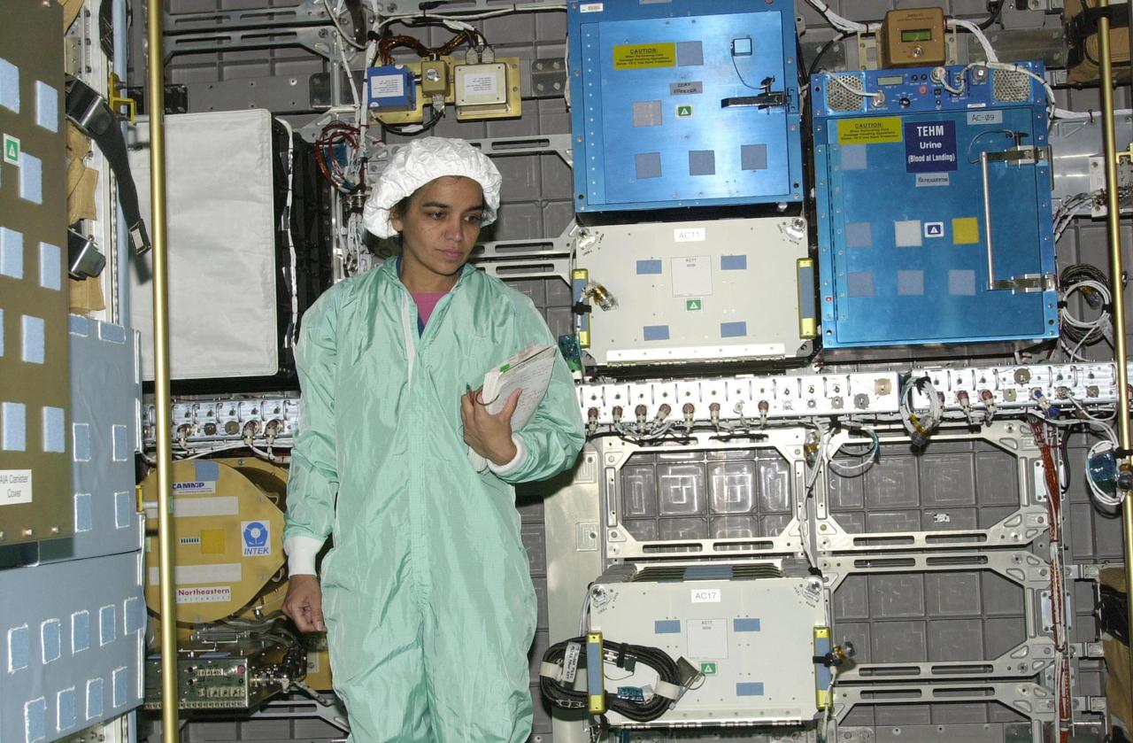 KENNEDY SPACE CENTER, FLA. - STS-107 Mission Specialist Kalpana Chawla looks at equipment inside the SHI Research Double Module (SHI/RDM), part of the payload on the mission. The crew is taking part in Crew Equipment Interface Test activities, which include equipment and payload familiarization. A research mission, STS-107 also will carry the Fast Reaction Experiments Enabling Science, Technology, Applications and Research (FREESTAR) that incorporates eight high priority secondary attached shuttle experiments. STS-107 is scheduled to launch July 19, 2002