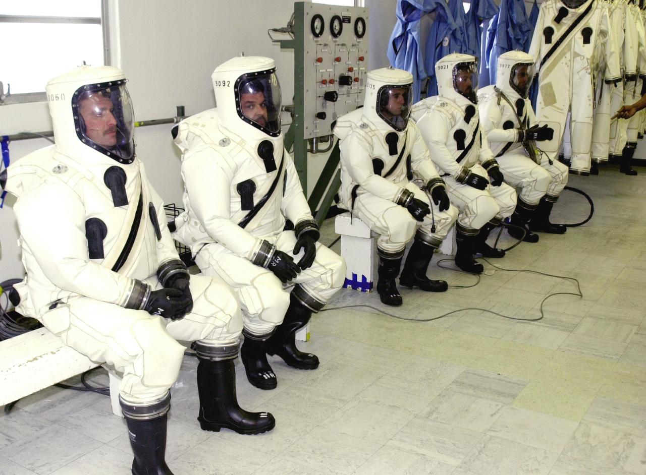 KENNEDY SPACE CENTER, FLA. - Dressed in their SCAPE suits, workers are ready for the fueling of the Comet Nucleus Tour (CONTOUR) spacecraft in the Spacecraft Assembly and Encapsulation Facility 2 (SAEF-2).  SCAPE refers to Self-Contained Atmospheric Protective Ensemble.  CONTOUR will provide the first detailed look into the heart of a comet -- the nucleus. Flying as close as 60 miles (100 kilometers) to at least two comets, the spacecraft will take the sharpest pictures yet of a nucleus while analyzing the gas and dust that surround them.  CONTOUR is scheduled for launch aboard a Boeing Delta II rocket July 1, 2002, from Launch Complex 17-A, Cape Canaveral Air Force Station