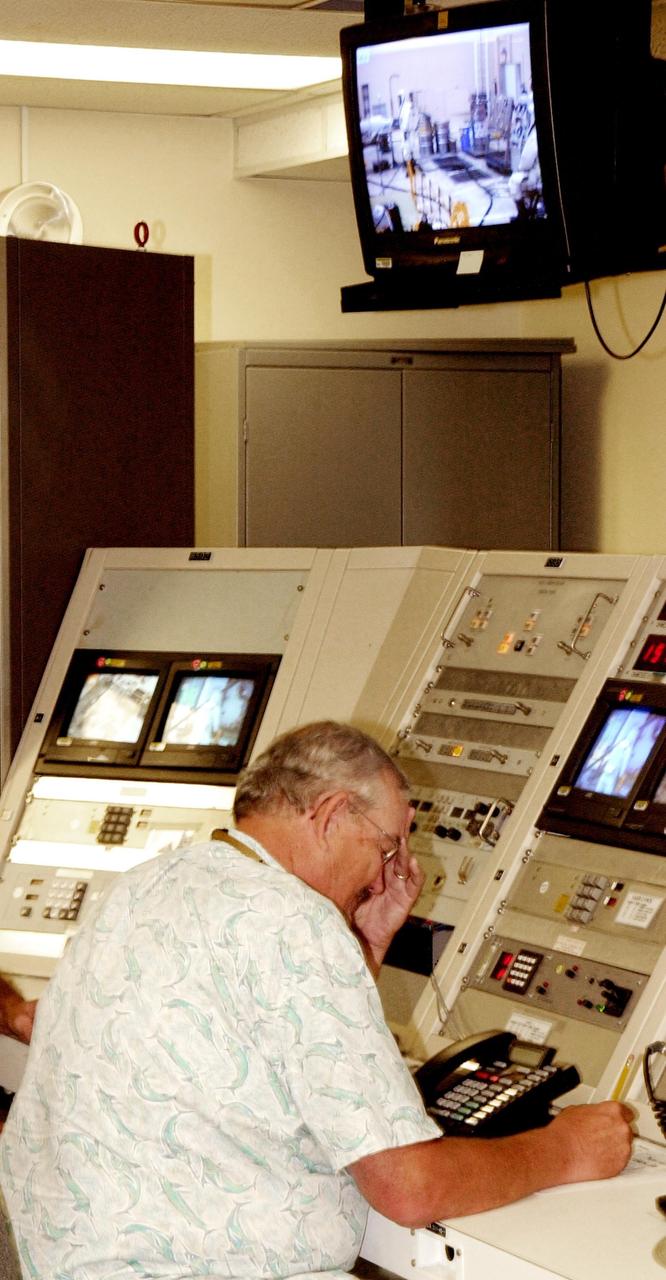 KENNEDY SPACE CENTER, FLA. --  In the Spacecraft Assembly and Encapsulation Facility 2 (SAEF-2) a worker monitors the fueling of the Comet Nucleus Tour (CONTOUR) spacecraft.  SCAPE refers to Self-Contained Atmospheric Protective Ensemble.  CONTOUR will provide the first detailed look into the heart of a comet -- the nucleus. Flying as close as 60 miles (100 kilometers) to at least two comets, the spacecraft will take the sharpest pictures yet of a nucleus while analyzing the gas and dust that surround them.  CONTOUR is scheduled for launch aboard a Boeing Delta II rocket July 1, 2002, from Launch Complex 17-A, Cape Canaveral Air Force Station