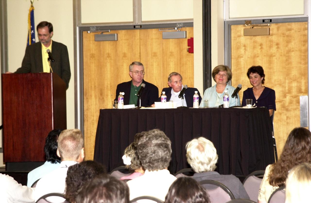 KENNEDY SPACE CENTER, FLA. -- The 2002 Florida Press Association and Florida Society of Newspaper Editors Convention offers a panel on space.  At the podium is Bob Stover, managing editor, Florida Today.  Panel participants enjoying a laugh are (left to right) Craig Covault, senior editor, Aviation Week; Howard Benedict, retired AP reporter; JoAnn Morgan, director, External Relations and Business Development, Kennedy Space Center; Marcia Dunn, AP reporter.  The convention was held at the Debus Center, KSC Visitors Complex. Also speaking at the convention were Center Director Roy Bridges and NASA Associate Deputy Administrator Dr. Daniel Mulville