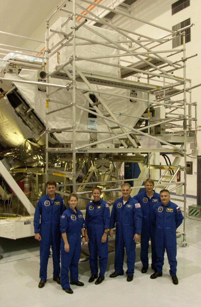 KENNEDY SPACE CENTER, FLA. -- The STS-112 crew gathers in front of structures in the Space Station Processing Facility where they have been looking over part of the payload as part of the Crew Equipment Interface Test activities. From left are Commander Jeffrey Ashby, Pilot Pamela Melroy and Mission Specialists Sandra Magnus, David Wolf, Piers Sellers and Fyodor Yurchikhin, who is with the Russian Space Agency. The S1 truss is the first starboard (right-side) truss segment for the International Space Station, whose main job is providing structural support for the orbiting research facility's radiator panels that cool the Station's complex power system. The S1 truss segment also will house communications systems, external experiment positions and other subsystems. The S1 truss will be attached to the S0 truss. Launch of STS-112 is scheduled for Aug. 22, 2002