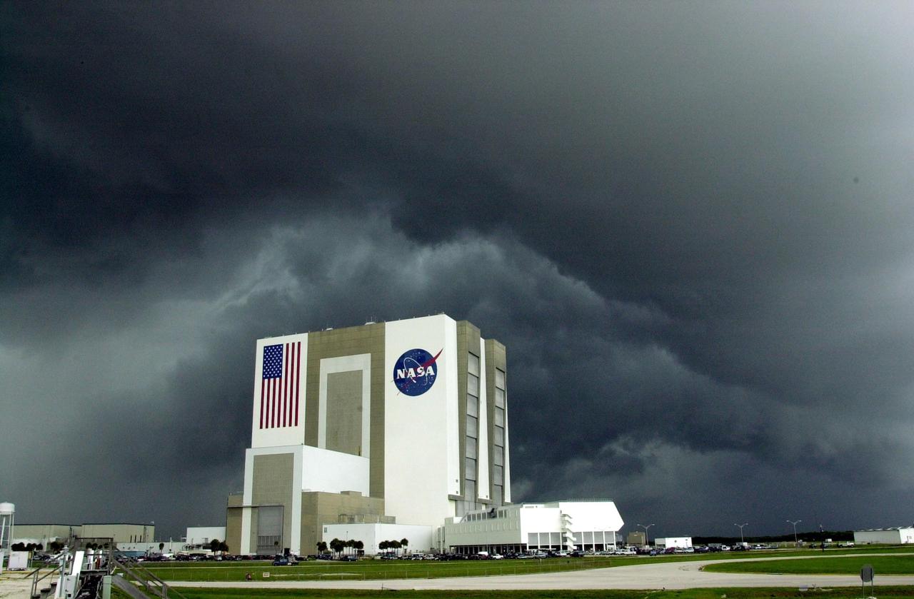 KENNEDY SPACE CENTER, FLA. -- Black storm clouds roll in over the Vehicle Assembly Building, bringing thunder and heavy rain. This type of weather convinced flight control managers to wave off the two scheduled landing attempts at KSC for Endeavour, returning from mission STS-111