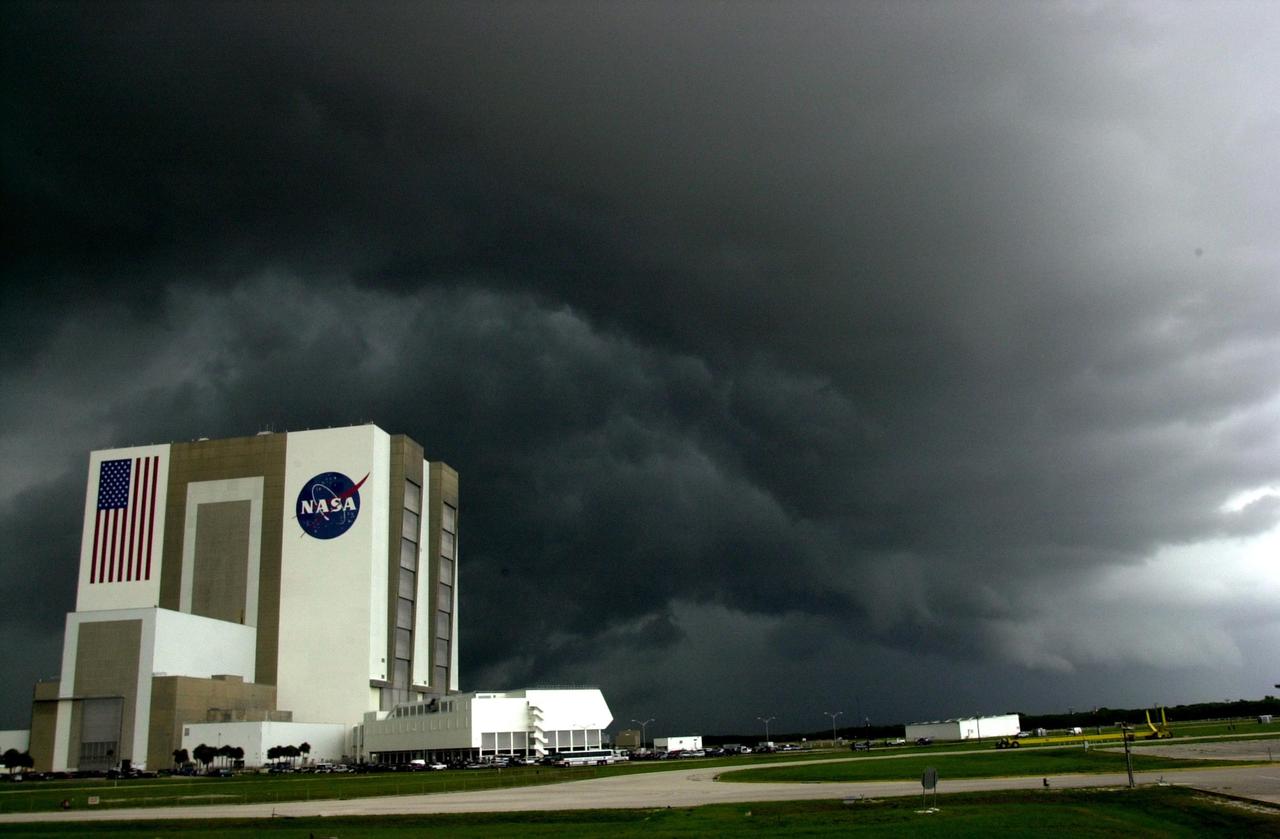 KENNEDY SPACE CENTER, FLA. -- Black storm clouds hang over the Vehicle Assembly Building and Launch Control Center, bringing thunder and heavy rain to the area. This type of weather convinced flight control managers to wave off the two scheduled landing attempts at KSC for Endeavour, returning from mission STS-111