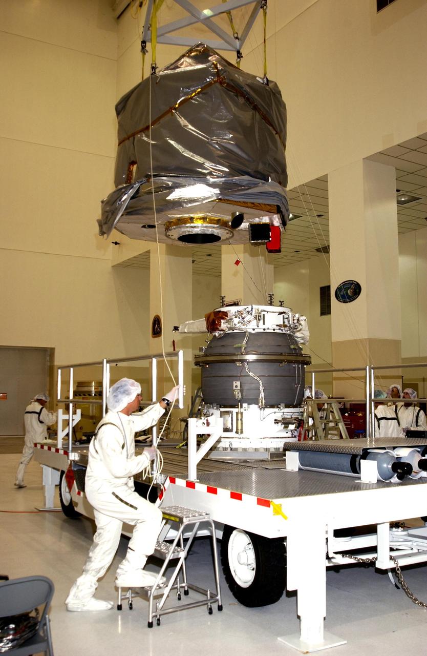 KENNEDY SPACE CENTER, FLA. - In the Space Assembly and Encapsulation Facility 2 (SAEF-2), the Comet Nucleus Tour (CONTOUR) spacecraft (top) is moved toward the upper stage of a Boeing Delta II rocket. The two will be mated for launch. CONTOUR will provide the first detailed look into the heart of a comet -- the nucleus. Flying as close as 60 miles (100 kilometers) to at least two comets, the spacecraft will take the sharpest pictures yet of a nucleus while analyzing the gas and dust that surround these rocky, icy building blocks of the solar system. Launch of CONTOUR aboard the Delta II is scheduled for July 1, 2002, from Launch Complex 17-A, Cape Canaveral Air Force Station