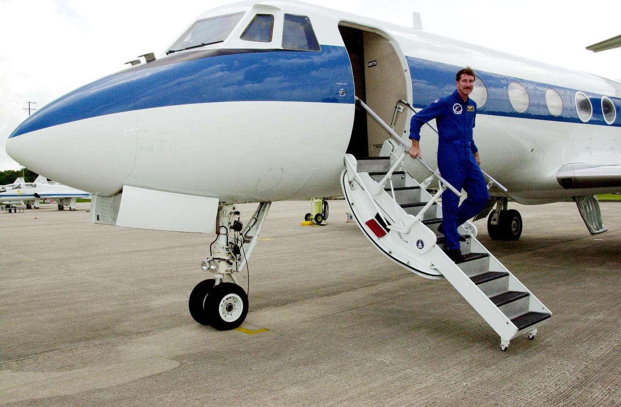 KENNEDY SPACE CENTER, FLA. -- Astronaut Kent Rominger exits the Shuttle Training Aircraft (STA) after flying weather reconnaissance for the landing of Endeavour, returning from mission STS-111. Low cloud cover and other unfavorable weather conditions resulted in the third day of wave off on two landing opportunities. Endeavour successfully landed at Edwards Air Force Base, Calif., completing 217 orbits and a 5.8-million-mile journey