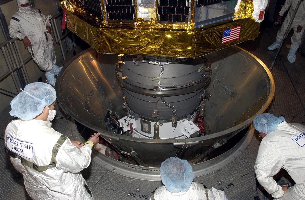 KENNEDY SPACE CENTER, FLA. -- -- On the launch tower at Launch Complex 17-A, Cape Canaveral Air Force Station, workers on different levels check the Comet Nucleus Tour (CONTOUR) spacecraft. CONTOUR will provide the first detailed look into the heart of a comet -- the nucleus. Flying as close as 60 miles (100 kilometers) to at least two comets, the spacecraft will take the sharpest pictures yet of a nucleus while analyzing the gas and dust that surround these rocky, icy building blocks of the solar system.  Launch of CONTOUR aboard a Boeing Delta II rocket is scheduled for July 1, 2002
