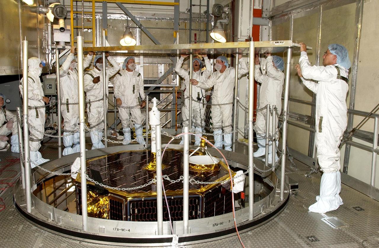 KENNEDY SPACE CENTER, FLA. -- Workers on the tower at Launch Complex 17-A, Cape Canaveral Air Force Station, fasten a support above the Comet Nucleus Tour (CONTOUR) spacecraft. CONTOUR will provide the first detailed look into the heart of a comet -- the nucleus. Flying as close as 60 miles (100 kilometers) to at least two comets, the spacecraft will take the sharpest pictures yet of a nucleus while analyzing the gas and dust that surround these rocky, icy building blocks of the solar system. Launch of CONTOUR aboard a Boeing Delta II rocket is scheduled for July 1, 2002