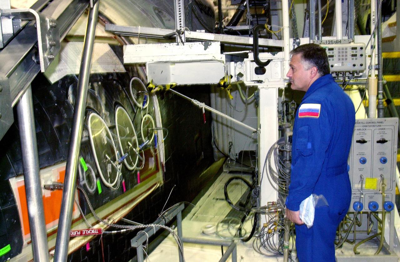 KENNEDY SPACE CENTER, FLA. -- During a Crew Equipment Interface Test, STS-112 Mission Specialist Fyodor Yurchikhin looks at Atlantis, the designated orbiter for the mission. Yurchikhin is with the Russian Space Agency. STS-112 is the 15th assembly flight to the International Space Station and will be ferrying the S1 Integrated Truss Structure. The S1 truss is the first starboard (right-side) truss segment, whose main job is providing structural support for the radiator panels that cool the Space Station's complex power system. The S1 truss segment also will house communications systems, external experiment positions and other subsystems. The S1 truss will be attached to the S0 truss. STS-112 is currently scheduled for launch Aug. 22, 2002