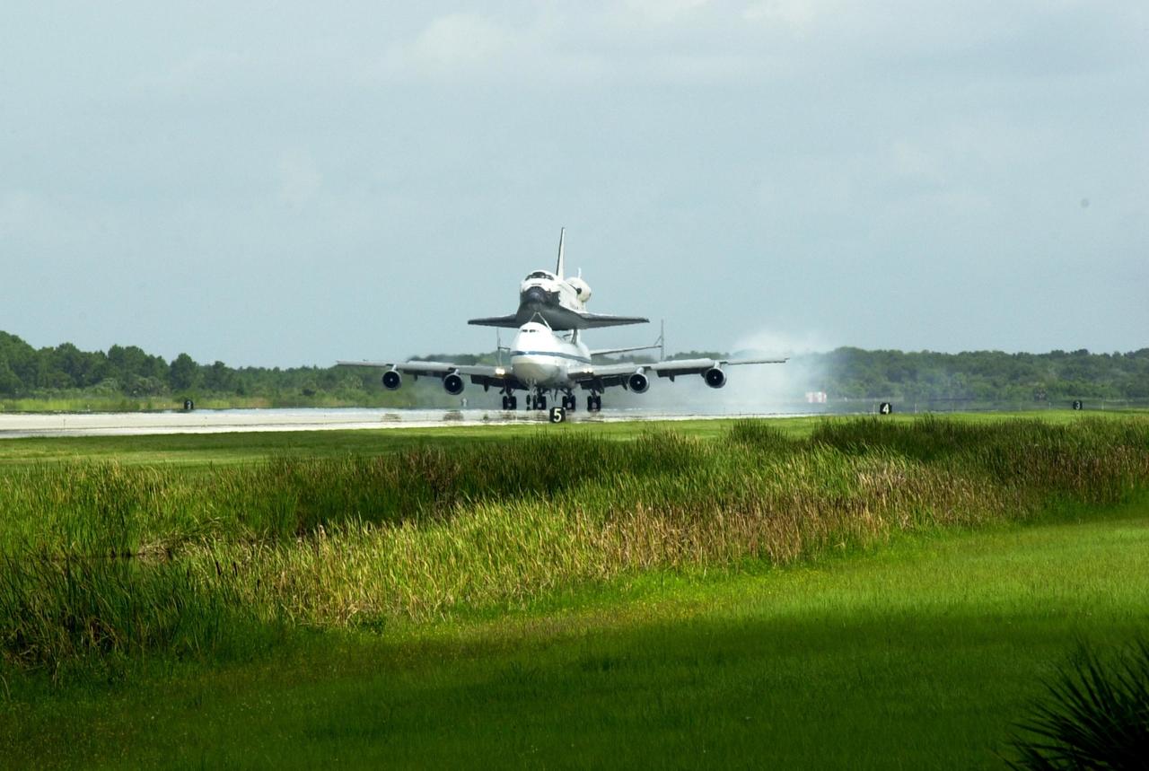KENNEDY SPACE CENTER, FLA. - Space Shuttle Endeavour lands on runway 15 at KSC's Shuttle Landing Facility at 10:58 a.m. EDT atop a modified Boeing 747 Shuttle Carrier Aircraft.  The cross-country ferry flight became necessary when three days of unfavorable weather conditions at KSC forced Endeavour to land on runway 22 at Dryden Flight Research Center, Edwards Air Force Base, Calif., on June 19 following mission STS-111.  Processing of Endeavour will now begin for the launch of mission STS-113 targeted for October 2002