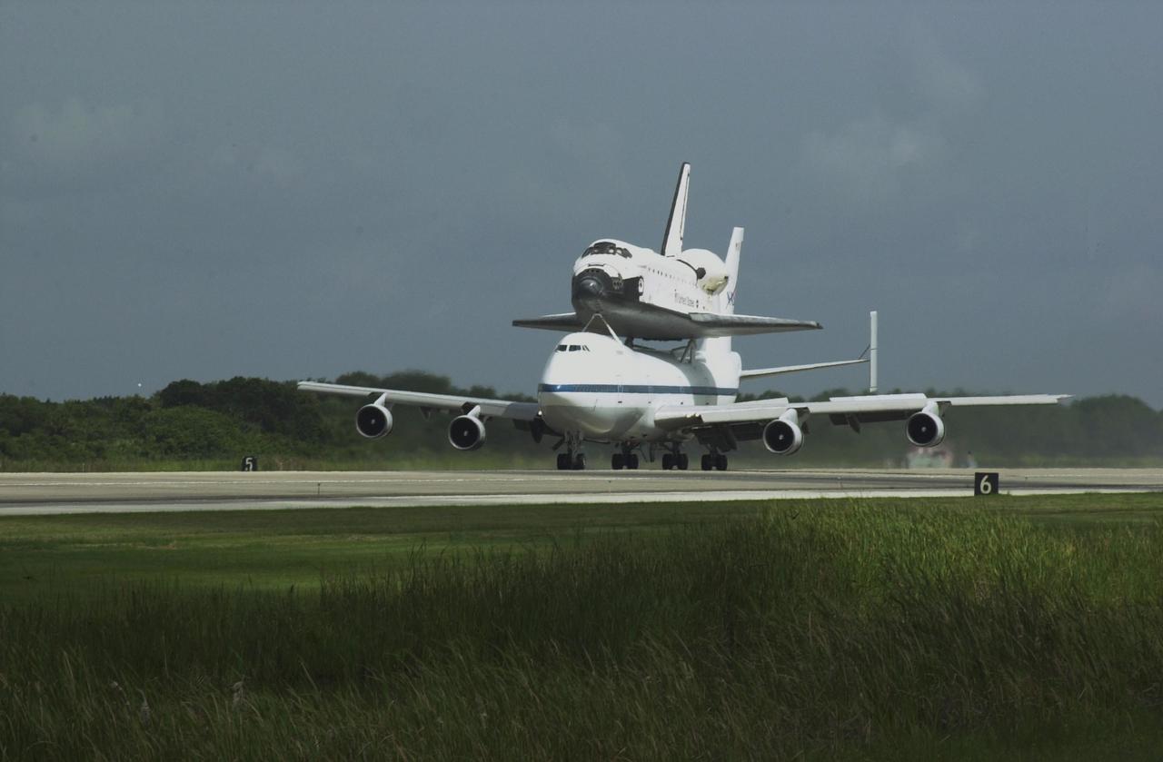 KENNEDY SPACE CENTER, FLA. - Space Shuttle Endeavour lands on runway 15 at KSC's Shuttle Landing Facility at 10:58 a.m. EDT atop a modified Boeing 747 Shuttle Carrier Aircraft.  The cross-country ferry flight became necessary when three days of unfavorable weather conditions at KSC forced Endeavour to land on runway 22 at Dryden Flight Research Center, Edwards Air Force Base, Calif., on June 19 following mission STS-111.  Processing of Endeavour will now begin for the launch of mission STS-113 targeted for October 2002