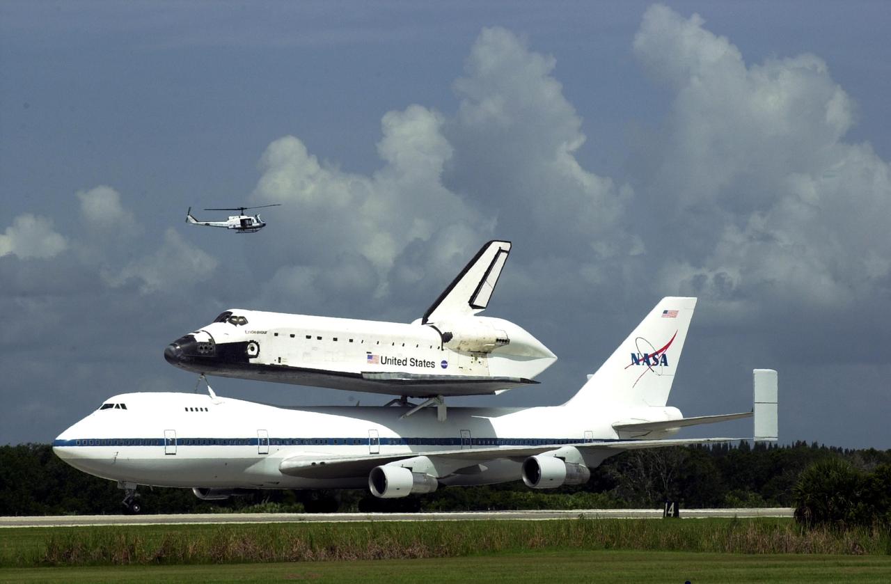 KENNEDY SPACE CENTER, FLA. - Space Shuttle Endeavour lands on runway 15 at KSC's Shuttle Landing Facility at 10:58 a.m. EDT atop a modified Boeing 747 Shuttle Carrier Aircraft.  The cross-country ferry flight became necessary when three days of unfavorable weather conditions at KSC forced Endeavour to land on runway 22 at Dryden Flight Research Center, Edwards Air Force Base, Calif., on June 19 following mission STS-111.  Processing of Endeavour will now begin for the launch of mission STS-113 targeted for October 2002
