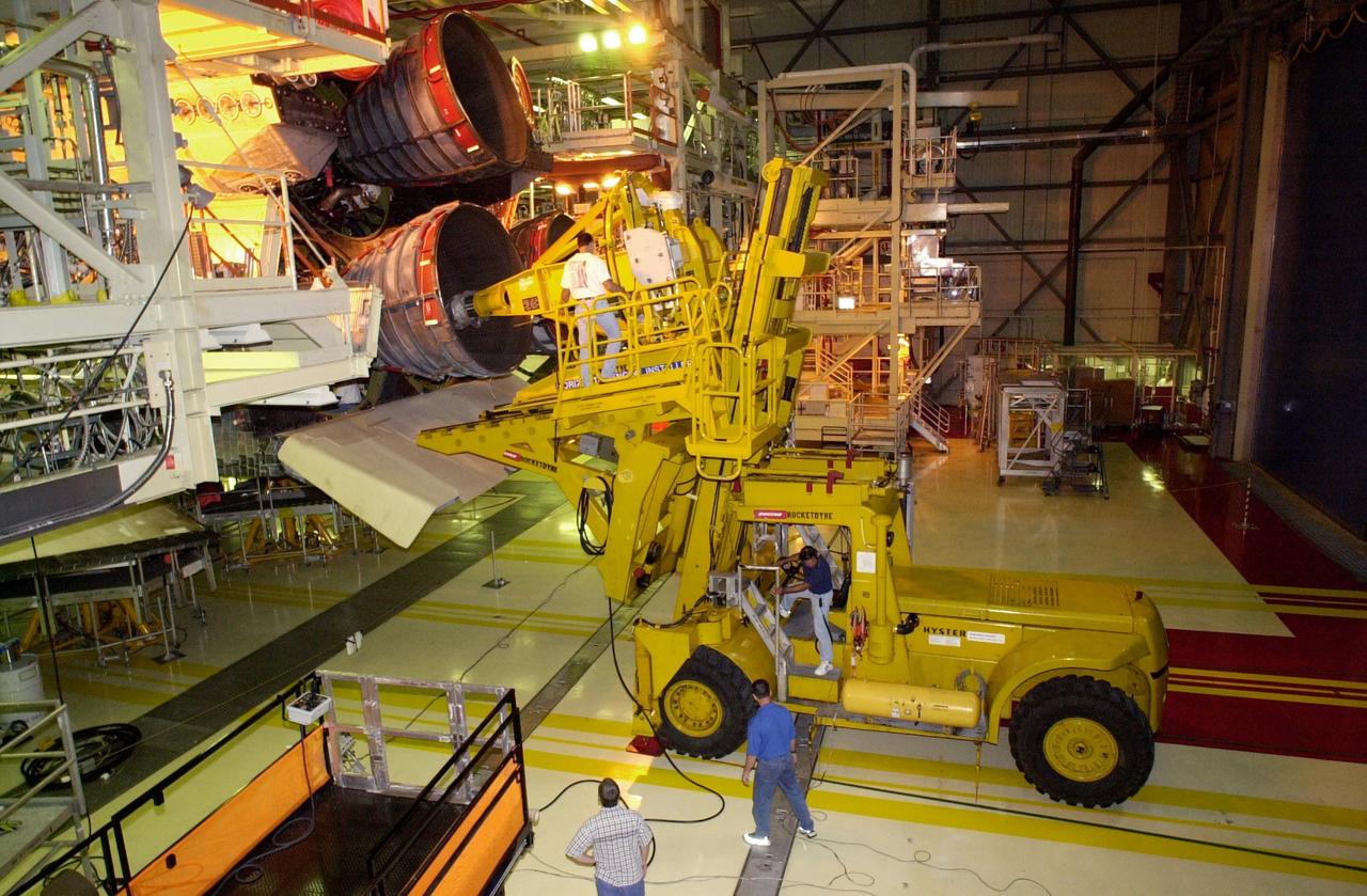 KENNEDY SPACE CENTER, FLA. --  In the Orbiter Processing Facility, Columbia's engine no. 2 is about to be removed. After small cracks were discovered on the LH2 Main Propulsion System (MPS) flow liners in two other orbiters, program managers decided to move forward with inspections on Columbia before clearing it for flight on STS-107. The heat shields were removed, and after removing the three main engines, inspections of the flow liners will follow.  The July 19 launch of Columbia on STS-107 has been delayed a few weeks