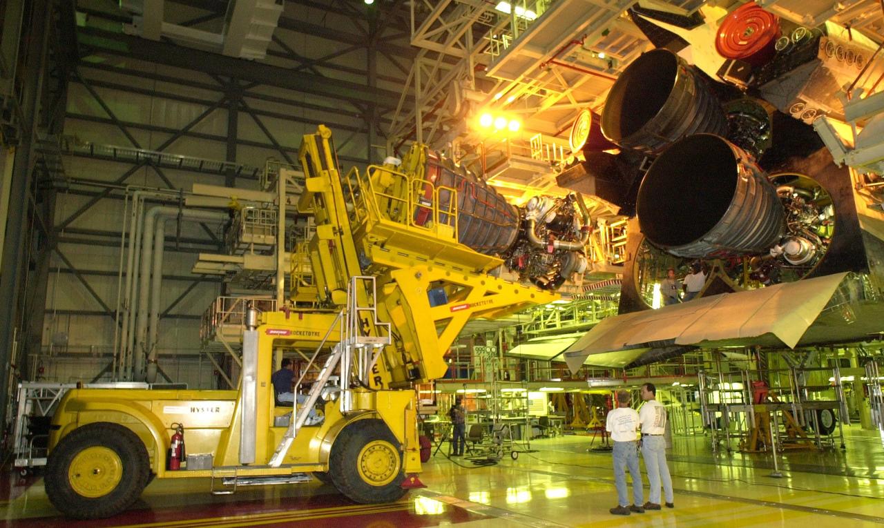 KENNEDY SPACE CENTER, FLA. -- In the Orbiter Processing Facility, Columbia's engine no. 2  is seen at left after its removal from the orbiter. After small cracks were discovered on the LH2 Main Propulsion System (MPS) flow liners in two other orbiters, program managers decided to move forward with inspections on Columbia before clearing it for flight on STS-107. The heat shields were removed, and after removing the three main engines, inspections of the flow liners will follow.  The July 19 launch of Columbia on STS-107 has been delayed a few weeks