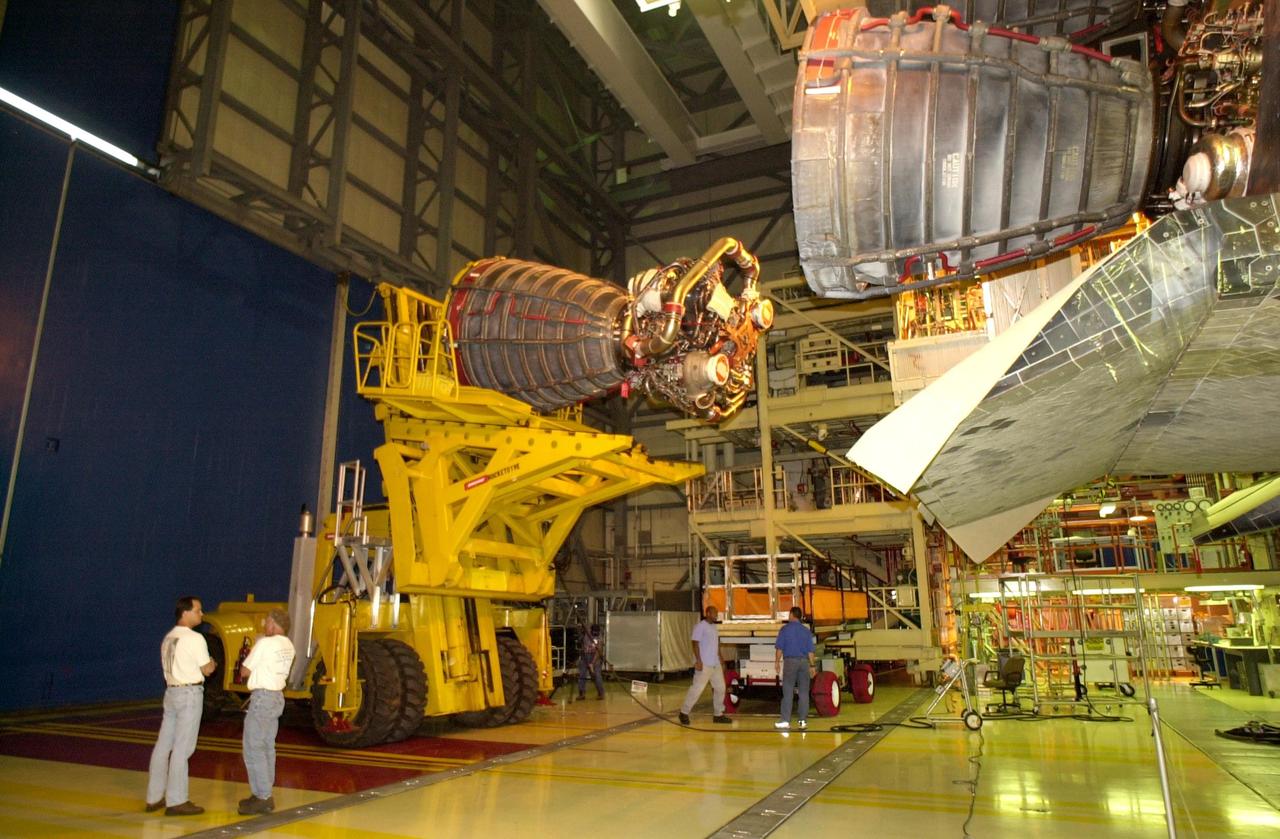 KENNEDY SPACE CENTER, FLA. -- In the Orbiter Processing Facility, Columbia's engine no. 2  is seen at left after its removal from the orbiter. After small cracks were discovered on the LH2 Main Propulsion System (MPS) flow liners in two other orbiters, program managers decided to move forward with inspections on Columbia before clearing it for flight on STS-107. The heat shields were removed, and after removing the three main engines, inspections of the flow liners will follow.  The July 19 launch of Columbia on STS-107 has been delayed a few weeks.    