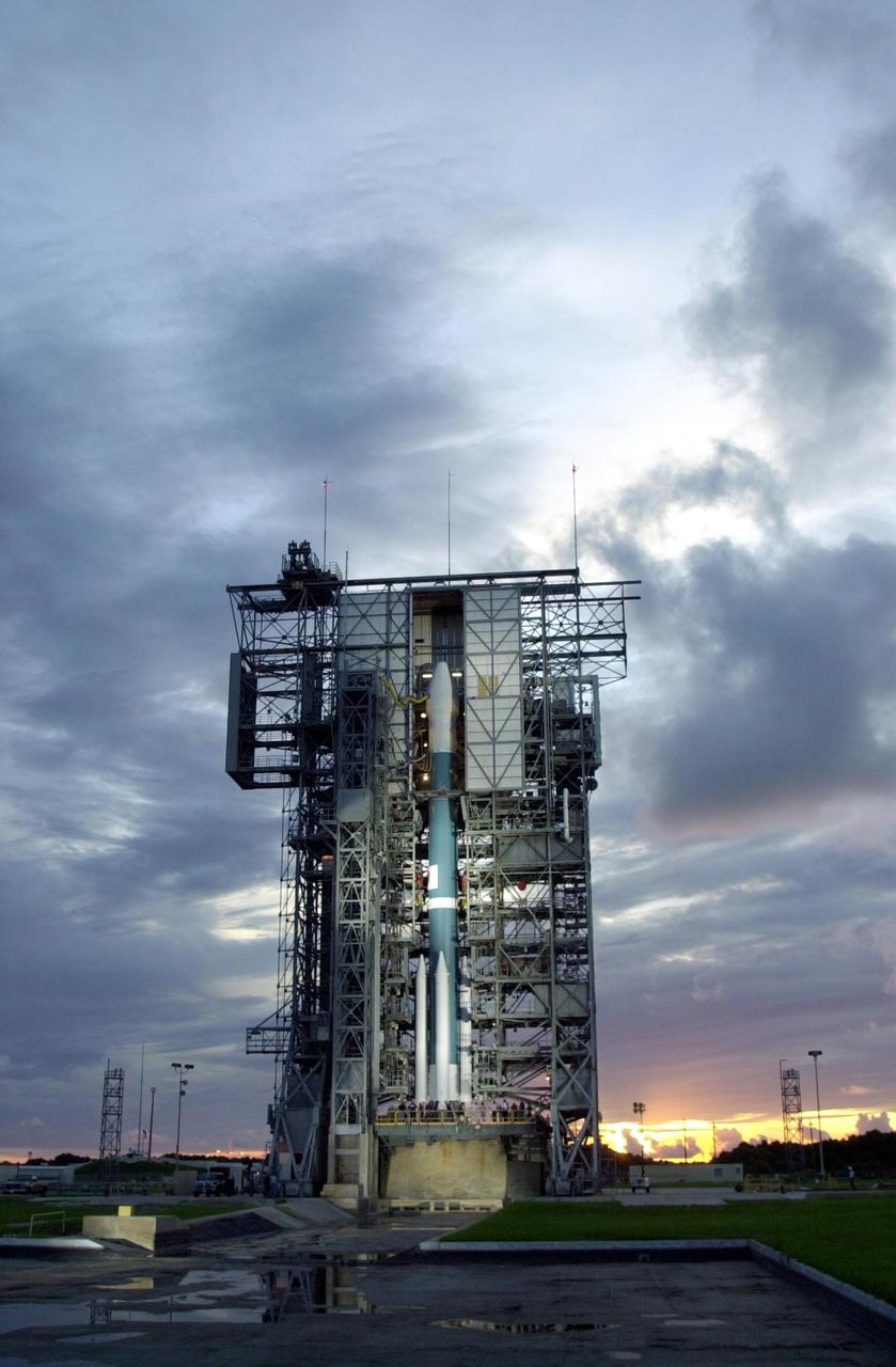 KENNEDY SPACE CENTER, FLA. -- The Boeing Delta II rocket with NASA's Comet Nucleus Tour (CONTOUR) spacecraft attached is visible as the launch tower is rolled back. The launch is scheduled for 2:47 a.m. EDT July 3 from Cape Canaveral Air Force Station, Fla. Designed and built by The Johns Hopkins University Applied Physics Laboratory (APL) in Laurel, Md., the 2,138-pound (970-kilogram) spacecraft will be placed into an elliptical Earth orbit until Aug. 15, when it is scheduled to fire its main engine and enter a comet-chasing orbit around the sun. The mission's flexible four-year plan includes encounters with comets Encke (Nov. 12, 2003) and Schwassmann-Wachmann 3 (June 19, 2006), though it can add an encounter with a "new" and scientifically valuable comet from the outer solar system, should one be discovered in time for CONTOUR to fly past it. CONTOUR's four scientific instruments will take detailed pictures and measure the chemical makeup of each comet's nucleus -- a chunk of ice and rock -- while analyzing the surrounding gas and dust.
