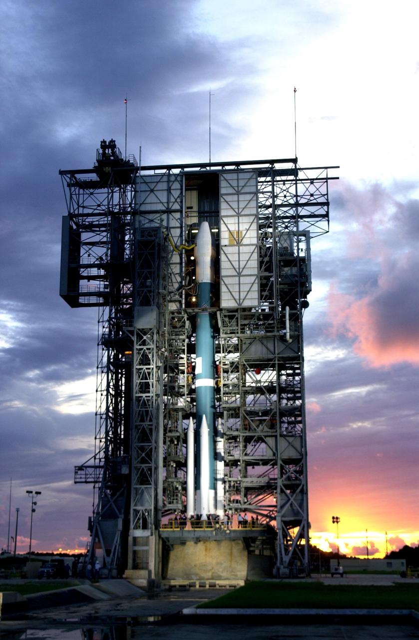 KENNEDY SPACE CENTER, FLA. -- The setting sun casts purple and pink shades in the sky as the launch tower on pad 17-A, Cape Canaveral Air Force Station, rolls back to reveal the Boeing Delta II rocket with NASA's Comet Nucleus Tour (CONTOUR) spacecraft attached. The launch is scheduled for 2:47 a.m. EDT July 3. Designed and built by The Johns Hopkins University Applied Physics Laboratory (APL) in Laurel, Md., the 2,138-pound (970-kilogram) spacecraft will be placed into an elliptical Earth orbit until Aug. 15, when it is scheduled to fire its main engine and enter a comet-chasing orbit around the sun. The mission's flexible four-year plan includes encounters with comets Encke (Nov. 12, 2003) and Schwassmann-Wachmann 3 (June 19, 2006), though it can add an encounter with a "new" and scientifically valuable comet from the outer solar system, should one be discovered in time for CONTOUR to fly past it. CONTOUR's four scientific instruments will take detailed pictures and measure the chemical makeup of each comet's nucleus -- a chunk of ice and rock -- while analyzing the surrounding gas and dust.