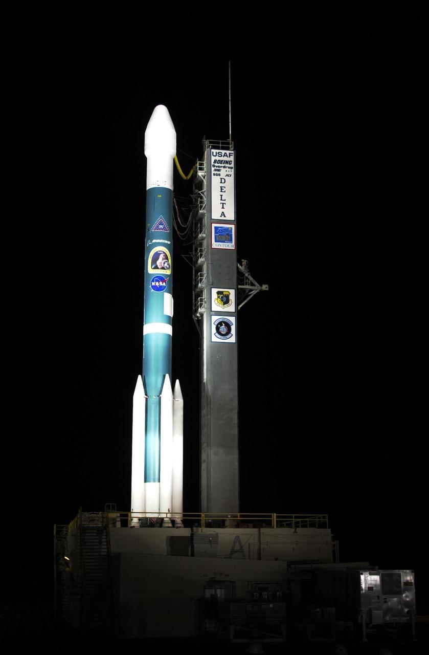 KENNEDY SPACE CENTER, FLA. -- The Boeing Delta II rocket with NASA's Comet Nucleus Tour (CONTOUR) spacecraft attached is bathed in light as it sits on pad 17-A, Cape Canaveral Air Force Station. The launch is scheduled for 2:47 a.m. EDT July 3. Designed and built by The Johns Hopkins University Applied Physics Laboratory (APL) in Laurel, Md., the 2,138-pound (970-kilogram) spacecraft will be placed into an elliptical Earth orbit until Aug. 15, when it is scheduled to fire its main engine and enter a comet-chasing orbit around the sun. The mission's flexible four-year plan includes encounters with comets Encke (Nov. 12, 2003) and Schwassmann-Wachmann 3 (June 19, 2006), though it can add an encounter with a "new" and scientifically valuable comet from the outer solar system, should one be discovered in time for CONTOUR to fly past it. CONTOUR's four scientific instruments will take detailed pictures and measure the chemical makeup of each comet's nucleus -- a chunk of ice and rock -- while analyzing the surrounding gas and dust.