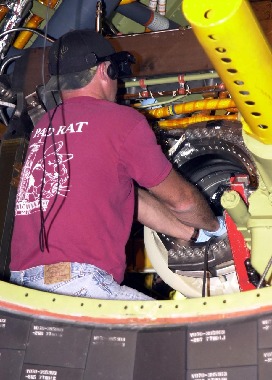 KENNEDY SPACE CENTER, FLA. -- Scott Minnick, with United Space Alliance, places a fiber-optic camera inside the flow line on Endeavour. Minnick wears a special viewing apparatus that sees where the camera is going. The inspection is the result of small cracks being discovered on the LH2 Main Propulsion System (MPS) flow liners in other orbiters. Endeavour is next scheduled to fly on mission STS-113.