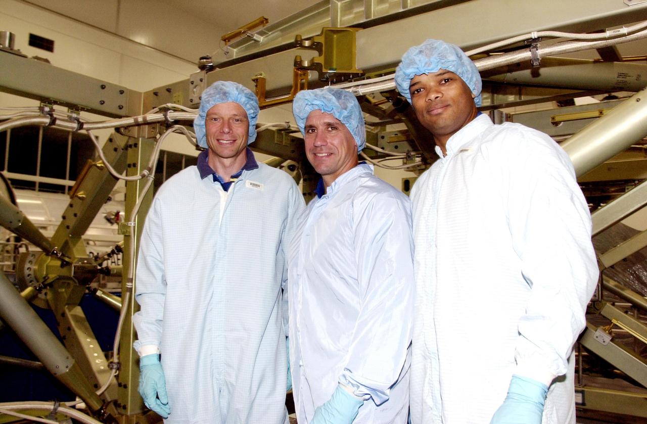 KENNEDY SPACE CENTER, FLA. -- During Crew Equipment Interface Test (CEIT), members of the STS-116 crew pose in front of trusses they will be working with during their mission to the International Space Station. From left are Mission Specialist Christer Fugelsang, with the European Space Agency, Pilot William Oefelein and Mission Specialist Robert Curbeam. The 19th assembly flight to the ISS, the mission will deliver the third port truss segment, the P5 Truss, to attach to second port truss segment, the P3/P4 Truss, to be assembled in an earlier mission. STS-116 is scheduled for launch in June 2003.
