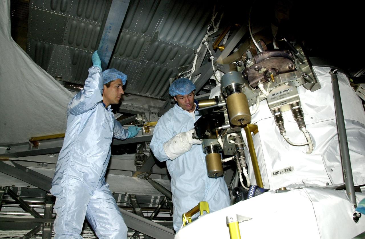 KENNEDY SPACE CENTER, FLA. -- STS-113 crew members look over equipment involved in their mission during Crew Equipment Interface Test activities in the Space Station Processing Facility. At left is Mission Specialist John Herrington; at right is Mission Specialist Michael Lopez-Alegria. Part of the payload on mission STS-113 is the first port truss segment, P1 Truss, to be attached to the central truss segment, S0, on the International Space Station. Once delivered, the P1 truss will remain stowed until flight 12A.1. Launch date for STS-113 is under review.