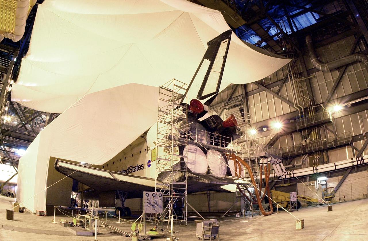 KENNEDY SPACE CENTER, FLA. -- Columbia sits inside an protective tent used to keep out moisture.  The orbiter is next scheduled to fly on mission STS-107 no earlier than Nov. 29.  STS-107 is a research mission. The payload includes the Hitchhiker Bridge, a carrier for the Fast Reaction Experiments Enabling Science, Technology, Applications and Research (FREESTAR) that incorporates eight high priority secondary attached shuttle experiments, plus the SHI Research Double Module (SHI/RDM), also known as SPACEHAB.