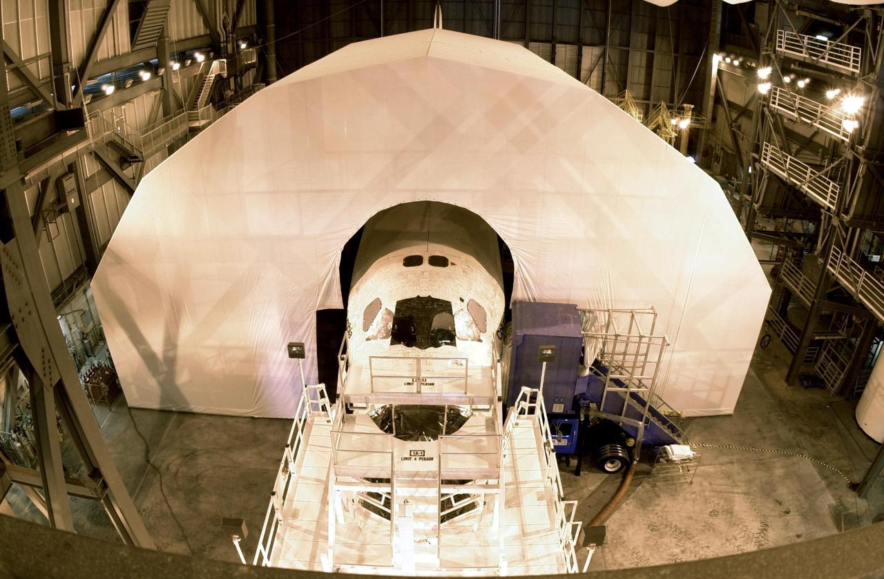 KENNEDY SPACE CENTER, FLA. -- Only the nose and tail of Columbia are visible as it sits inside an protective tent used to keep out moisture.  The orbiter is next scheduled to fly on mission STS-107 no earlier than Nov. 29.  STS-107 is a research mission. The payload includes the Hitchhiker Bridge, a carrier for the Fast Reaction Experiments Enabling Science, Technology, Applications and Research (FREESTAR) that incorporates eight high priority secondary attached shuttle experiments, plus the SHI Research Double Module (SHI/RDM), also known as SPACEHAB.