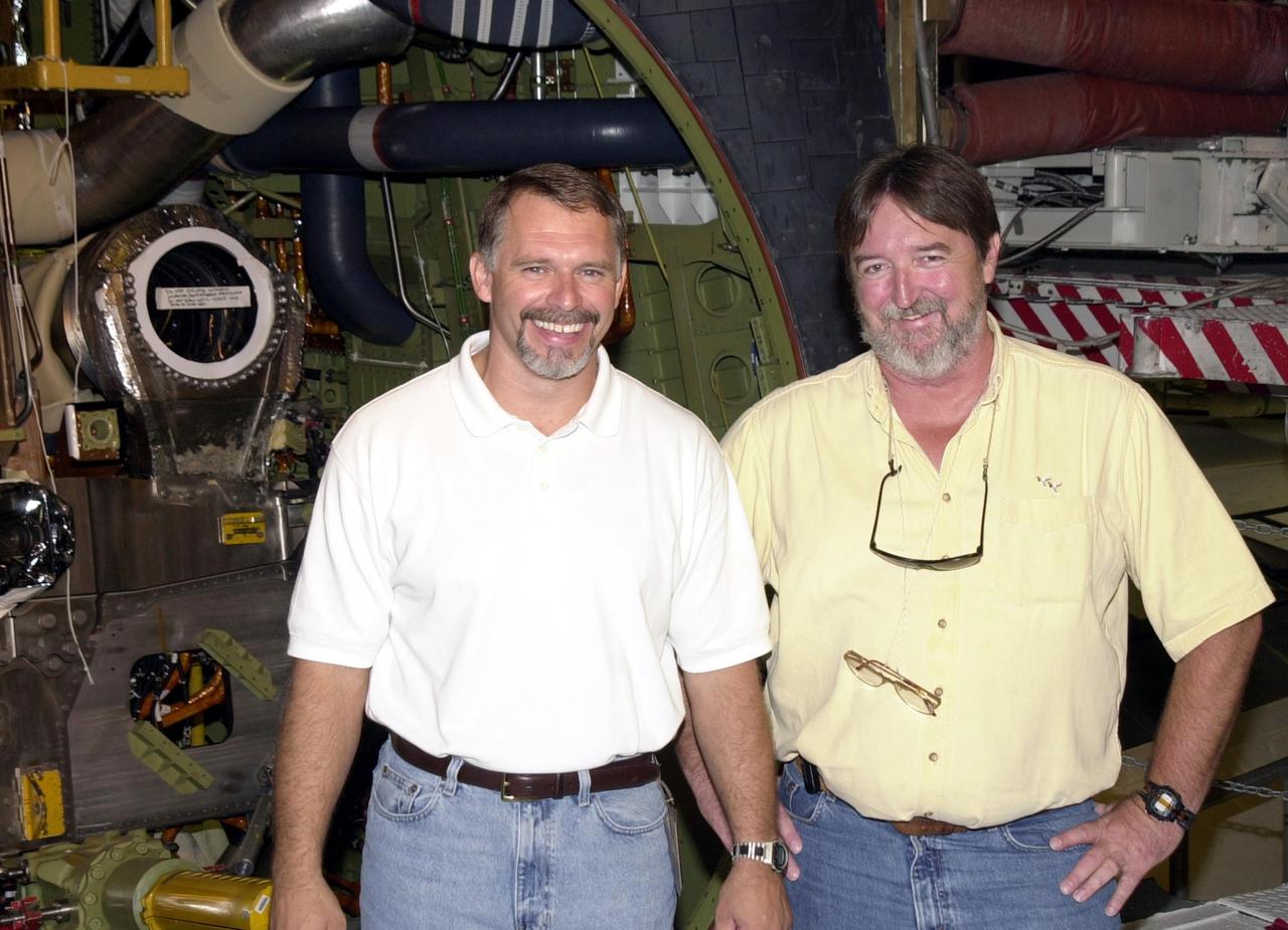 KENNEDY SPACE CENTER, FLA. - Welder Jerry Goudy (left), with United Space Alliance, and his backup Jack Weeks, with Marshall Space Flight Center - Boeing, are ready to begin welding the minute cracks on Endeavour's flow liners. Endeavour is scheduled to fly on mission STS-113 in November. The mission payload is the P1 Integrated Truss Structure, the first portside truss to go to the International Space Station, and will be attached to the central truss segment, S0, on the Station. Also additional cooling radiators will be delivered but will remain stowed until flight 12A.1.