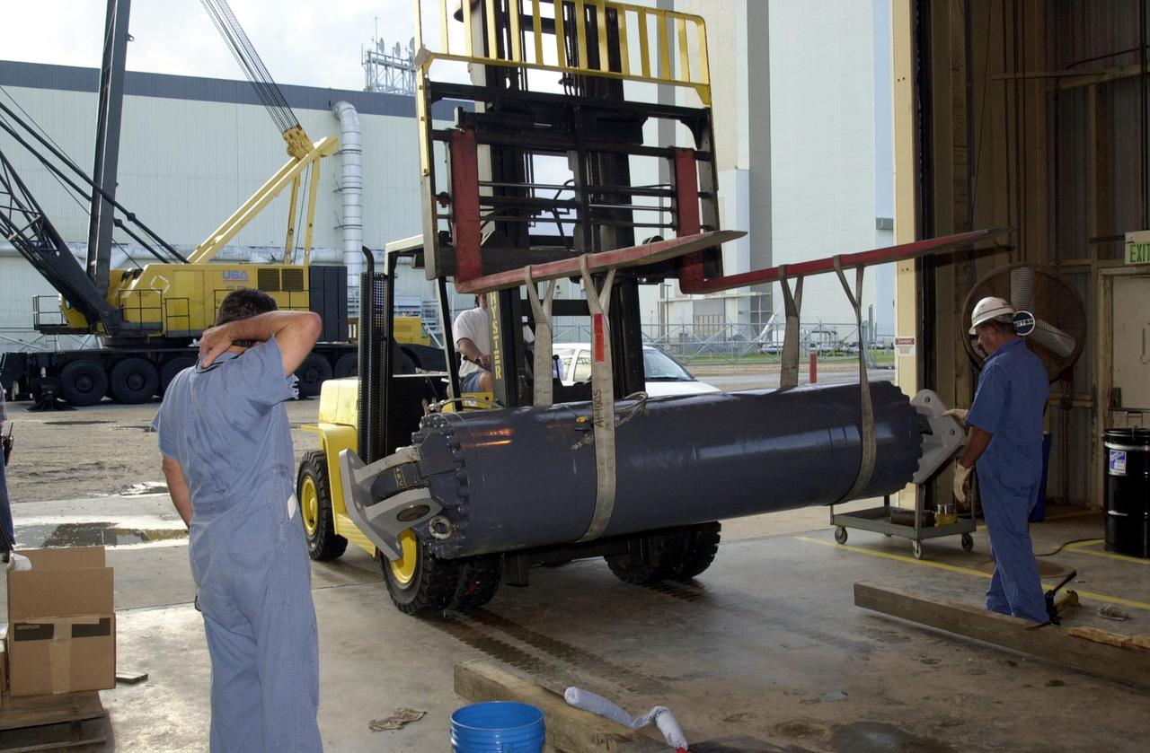 KENNEDY SPACE CENTER, FLA. --  One of the repaired Jacking, Equalization and Leveling (JEL) cylinders is moved from the repair site for installation into Crawler Transporter No. 2.  There are 16 cylinders and 32 bearings per crawler.  During recent routine maintenance inspections, technicians removed two of the 16 JEL cylinders on the crawler to gain access to the bearings and found three of the four bearings cracked.  Further eddy current inspections indicated that cracks were present on 15 of the bearings.. Technicians have removed and replaced 14 of the bearings on  CT-2, which is being repaired in order to enable Atlantis' rollout for mission STS-112, scheduled for launch no earlier than Oct. 2.