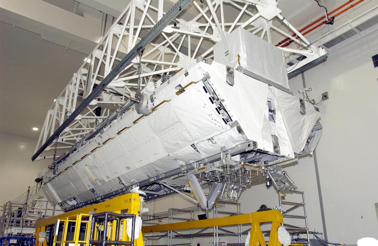 KENNEDY SPACE CENTER, FLA. -- An overhead crane lifts the S1 Integrated Truss Structure from its workstand. The S1 will be placed in the payload canister for transport it to Atlantis. The first starboard truss segment, the S1 will be attached to the Central truss segment, the S0 Truss, on the International Space Station during mission STS-112. Atlantis is scheduled to launch no earlier than Oct. 2.